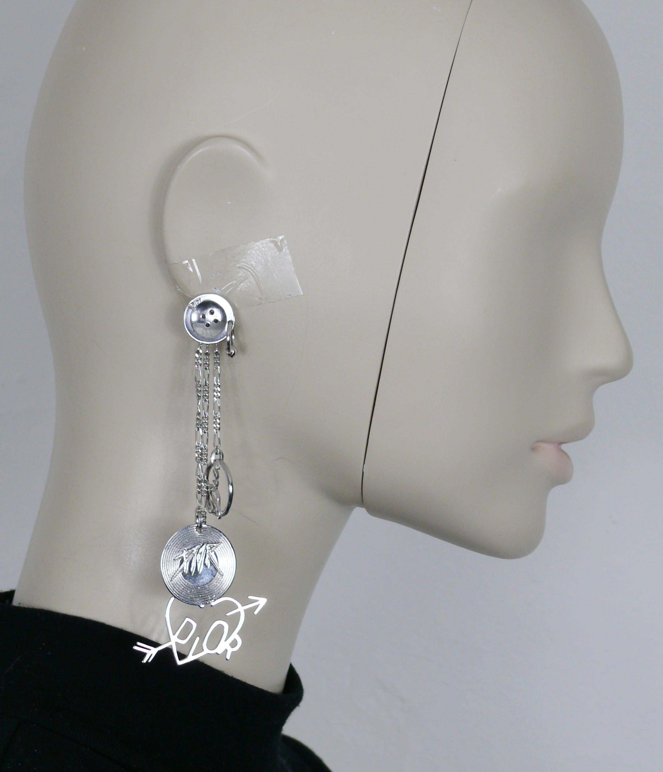CHRISTIAN DIOR by JOHN GALLIANO vintage silver tone dangling earrings (clip-on) featuring a pierced button top, three chains with charms : a record embossed DIOR, heart and DIOR signature medallion.

Embossed DIOR.

Indicative measurements : max.