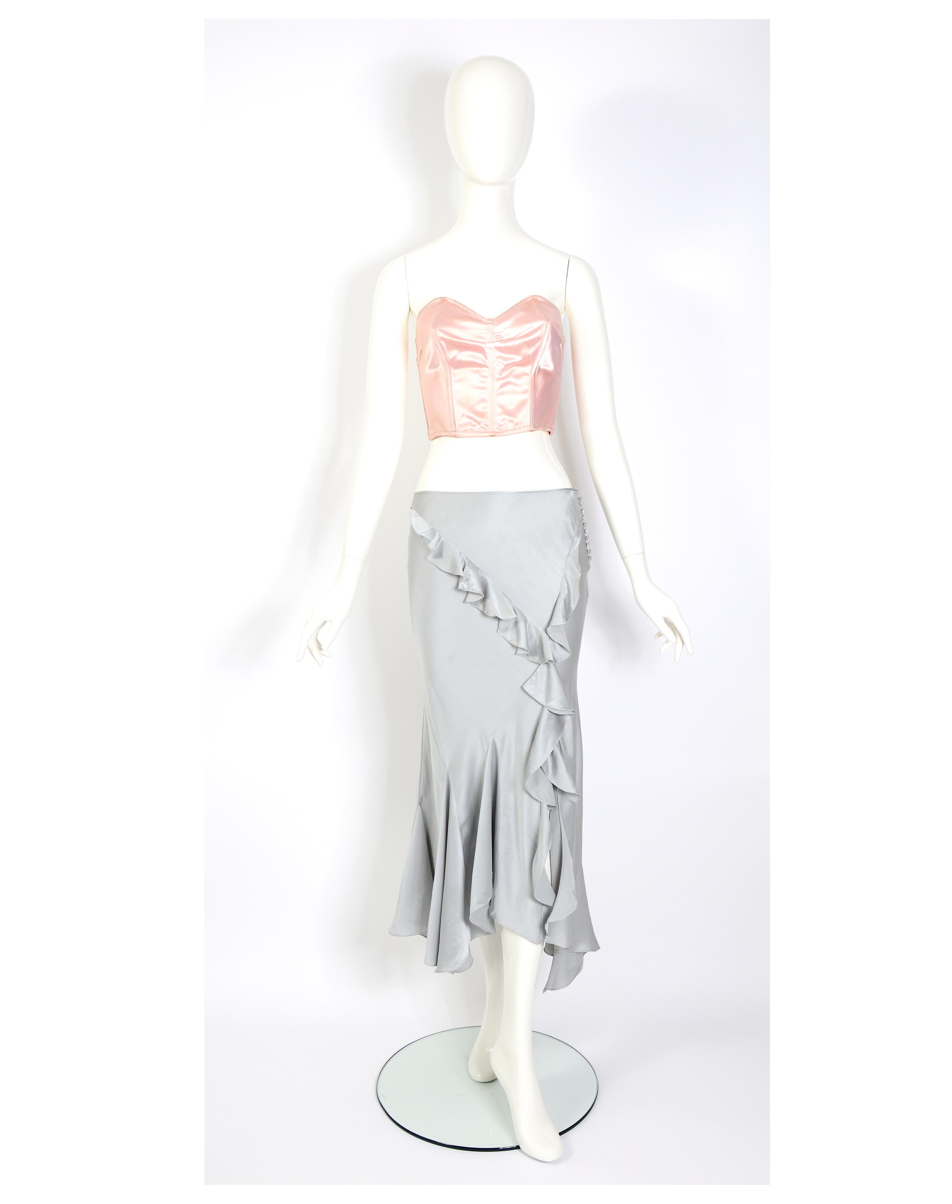 Verlaine Vintage is thrilled to present a stunning vintage piece from Christian Dior, designed by John Galliano. This exquisite silk satin skirt features elegant ruffles and is cut on the bias for a flattering fit. The low waist adds a touch of