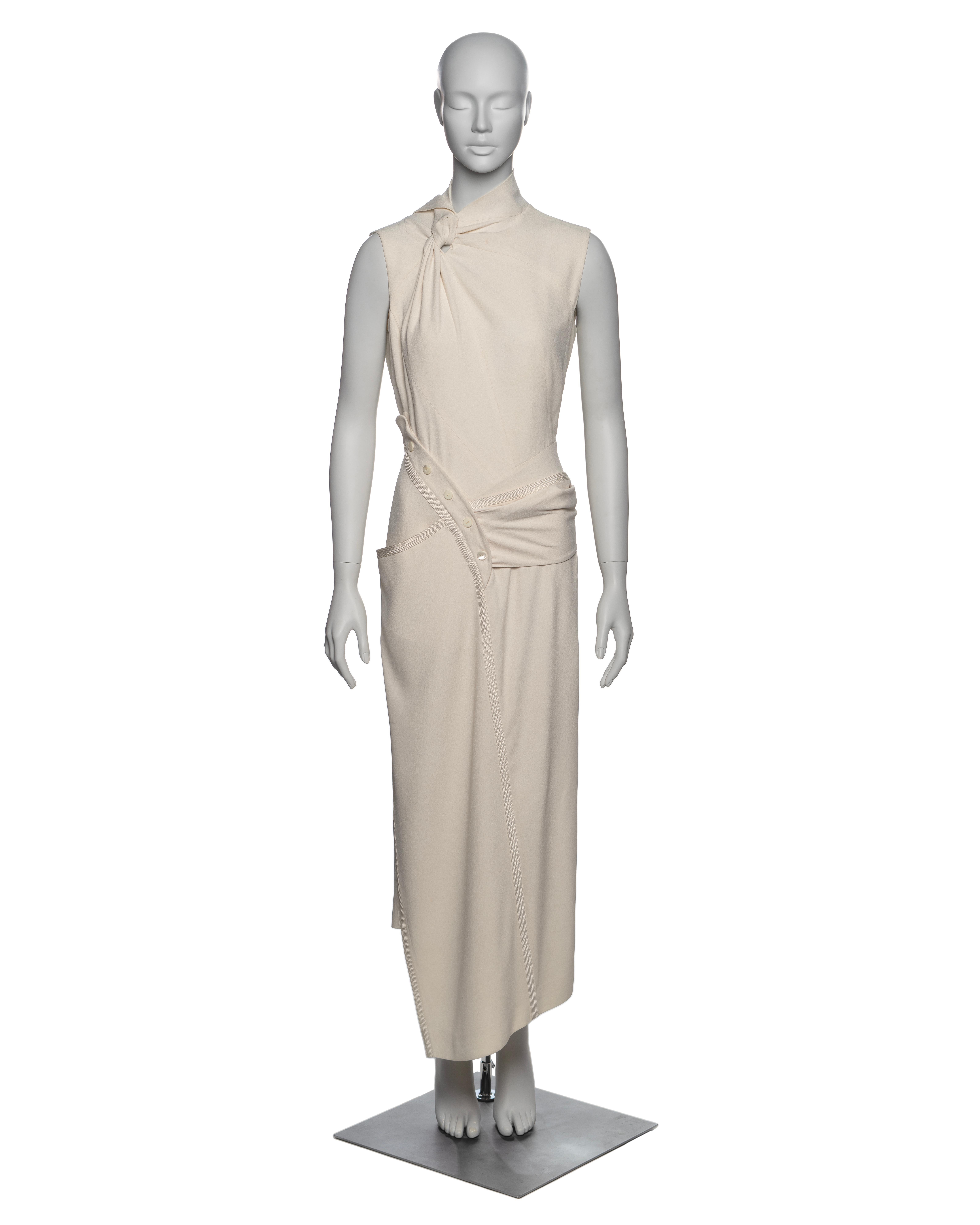 ▪ Brand: Christian Dior
▪ Creative Director: John Galliano
▪ Collection: Spring-Summer 2000
▪ Fabric: Ivory / White crepe and mulberry silk 
▪ Details: The dress features an asymmetric cut, highlighted by a twisted knot detail at the neckline. It