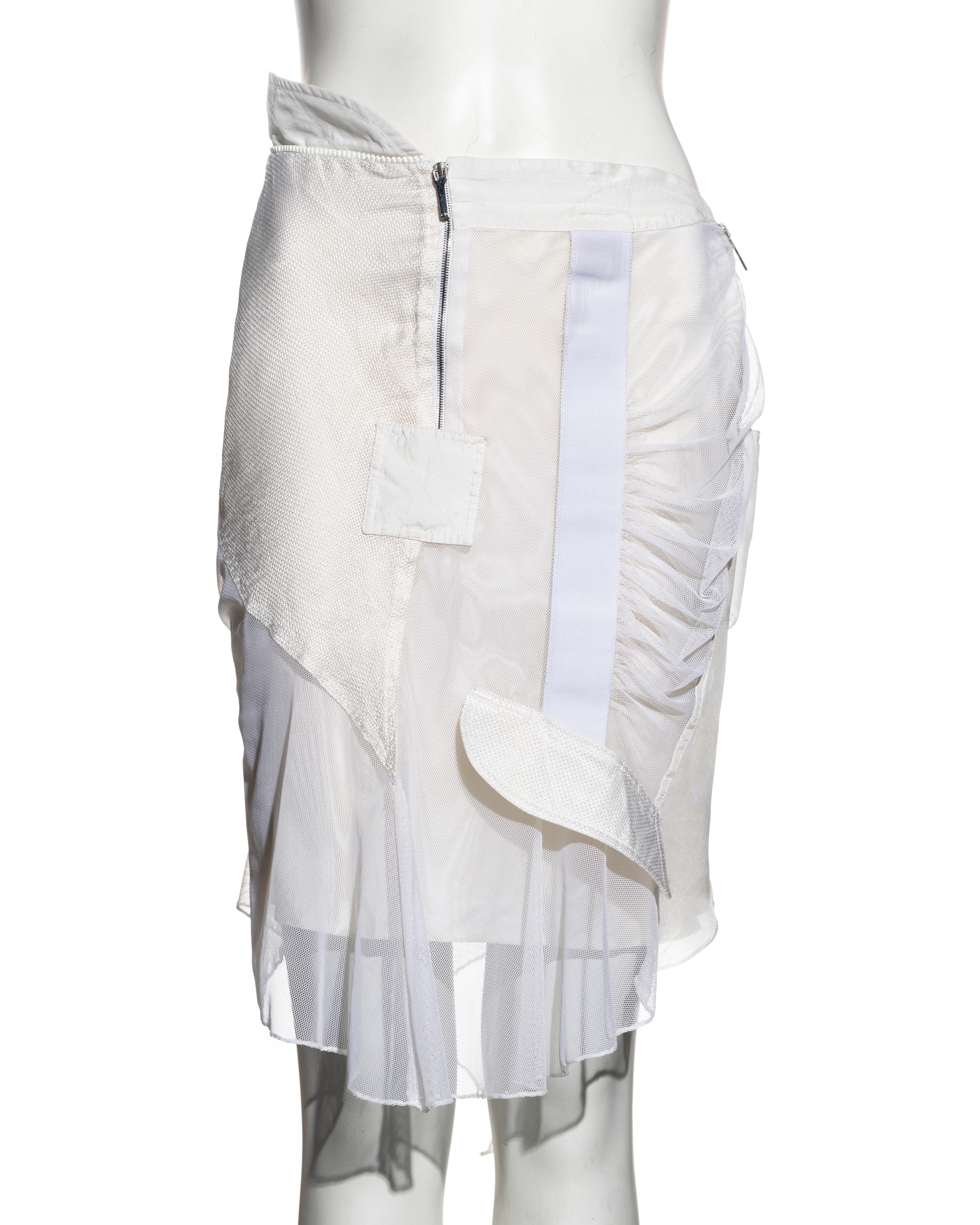 ▪ Christian Dior white deconstructed skirt
▪ Designed by John Galliano
▪ Nylon mesh overlay
▪ Silk lining 
▪ Asymmetric waist and hemline 
▪ Decorative pockets 
▪ FR 40 - UK 12 - US 8
▪ Spring-Summer 2002
▪ 60% Nylon, 40% Lycra. Lining: 95% Silk, 5%