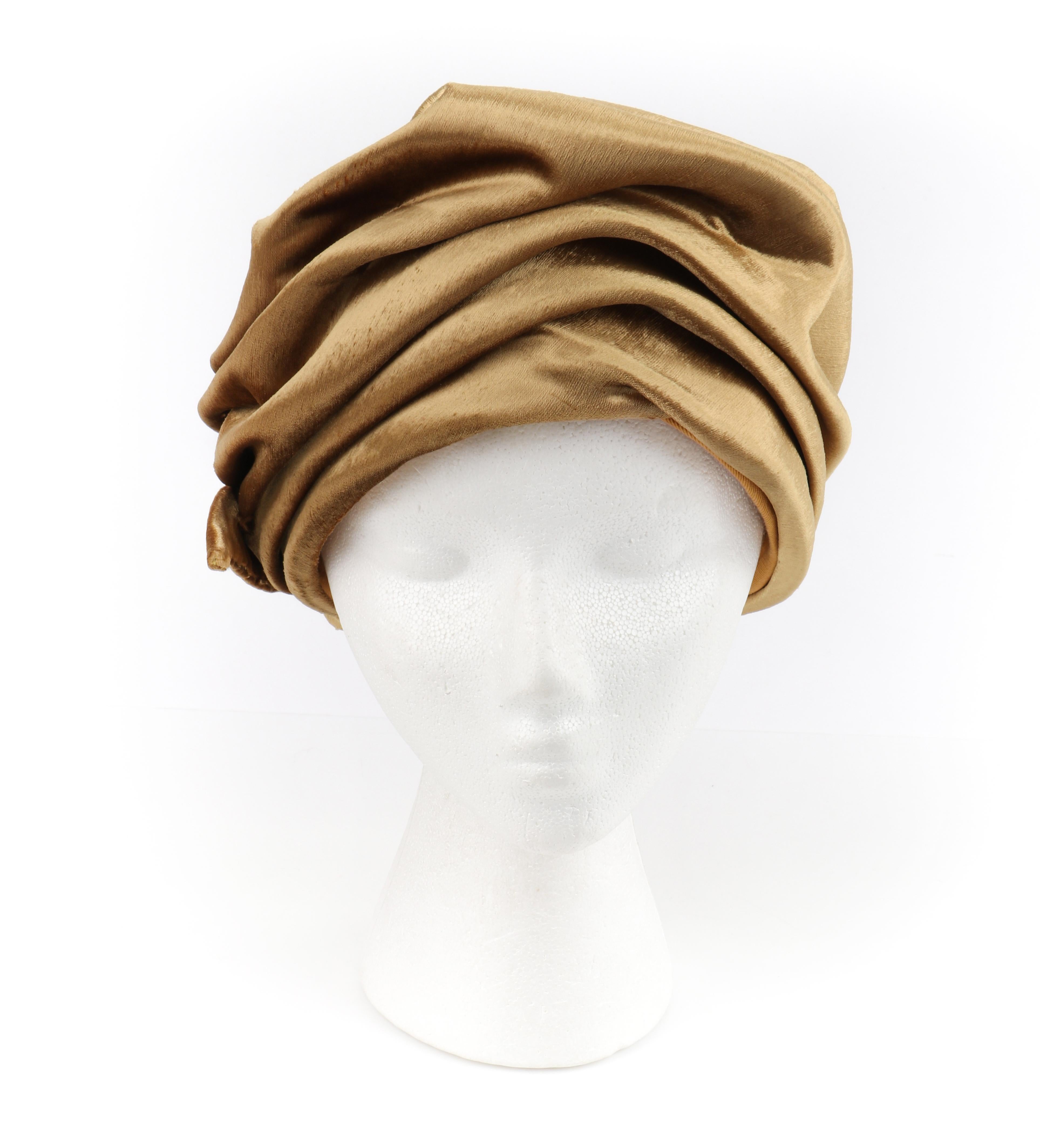 CHRISTIAN DIOR c.1960s Gold Silk Velvet Tied Back Bow Turban Cloche Hat
 
Circa: 1960’s
Label(s): Christian Dior Chapeaux; Union tag
Designer: Yves Saint Laurent
Style: Turban hat
Color(s): Shades of gold (exterior); warm brown (interior)
Lined: