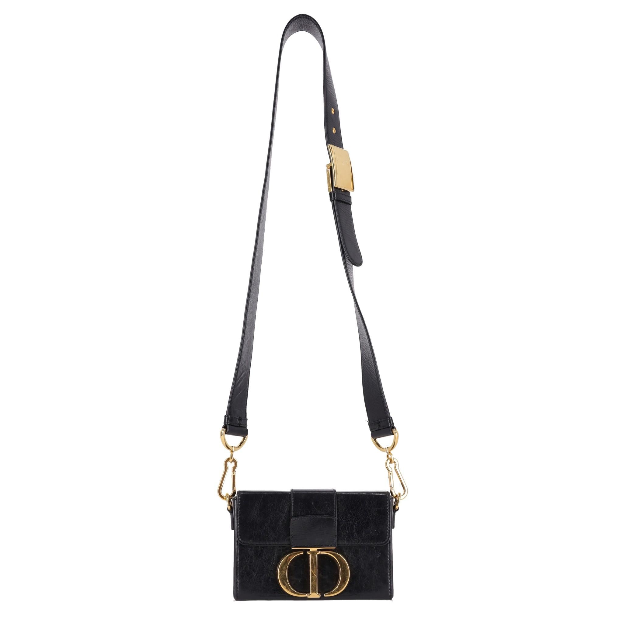 Christian Dior Calfskin Leather 30 Montaigne Box Bag

Black box bag crafted of calfskin leather in with signature 'CD' logo buckle in gold.

Designed with wide, adjustable, detachable shoulder/crossbody strap with gold, branded hardware.

Featuring