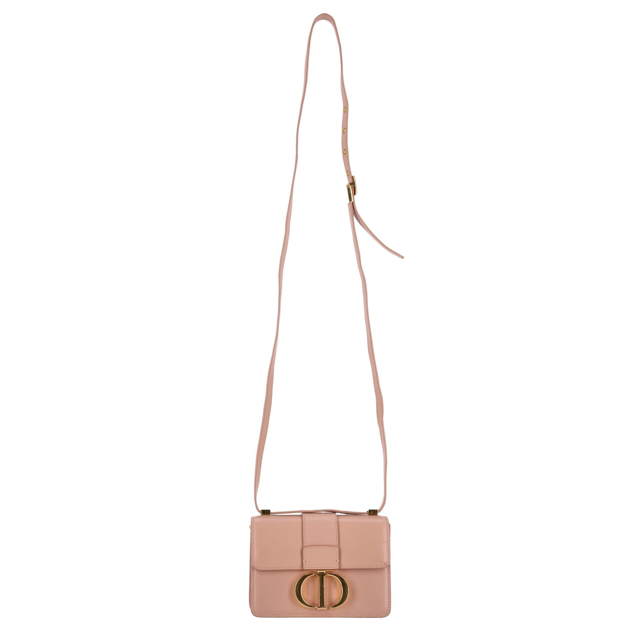 Christian Dior Calfskin Leather Micro 30 Montaigne Flap Bag

Beige box bag crafted of calfskin leather in Rose Des Vents.

Featuring signature 'CD' logo buckle in gold and adjustable, leather shoulder/crossbody strap.

Featuring front flap leading