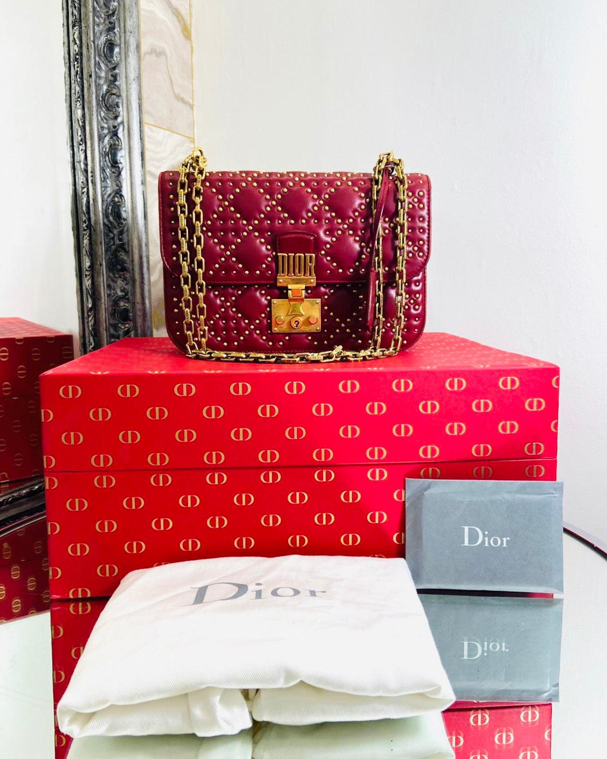 Christian Dior Cannage Dioraddict Studded Bag - Large Model

Red leather crossbody bag features a gold studded

and quilted body. Aged gold-tone chain link, detachable

shoulder strap with the links engraved with 'CD'.  Front flap

with a push-lock