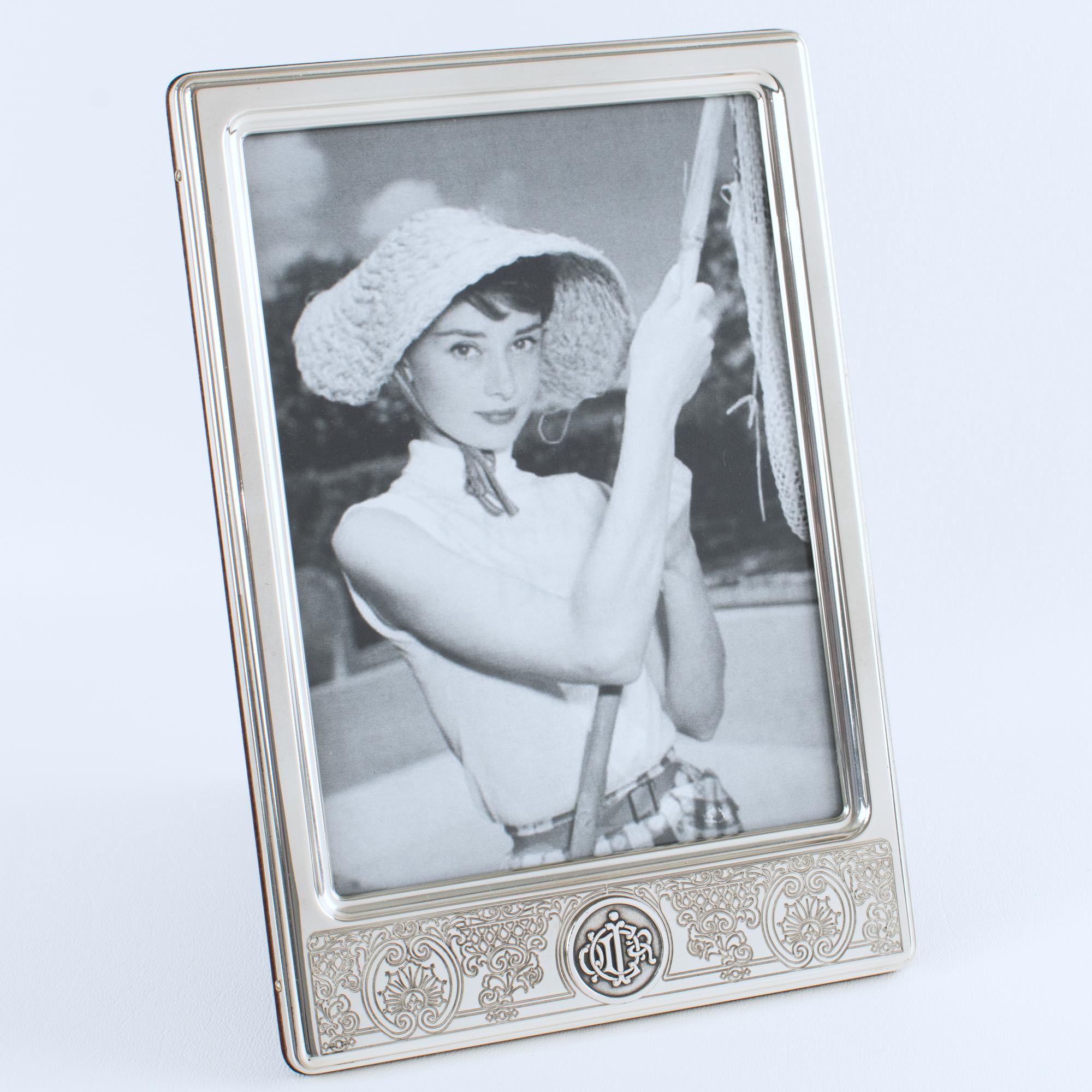 A stunning Christian Dior Paris sterling silver photo frame designed from the Dior Interior Collection. The exquisite piece was expertly crafted in France circa 1980. This tall, rectangular photo frame showcases a sophisticated asymmetric design