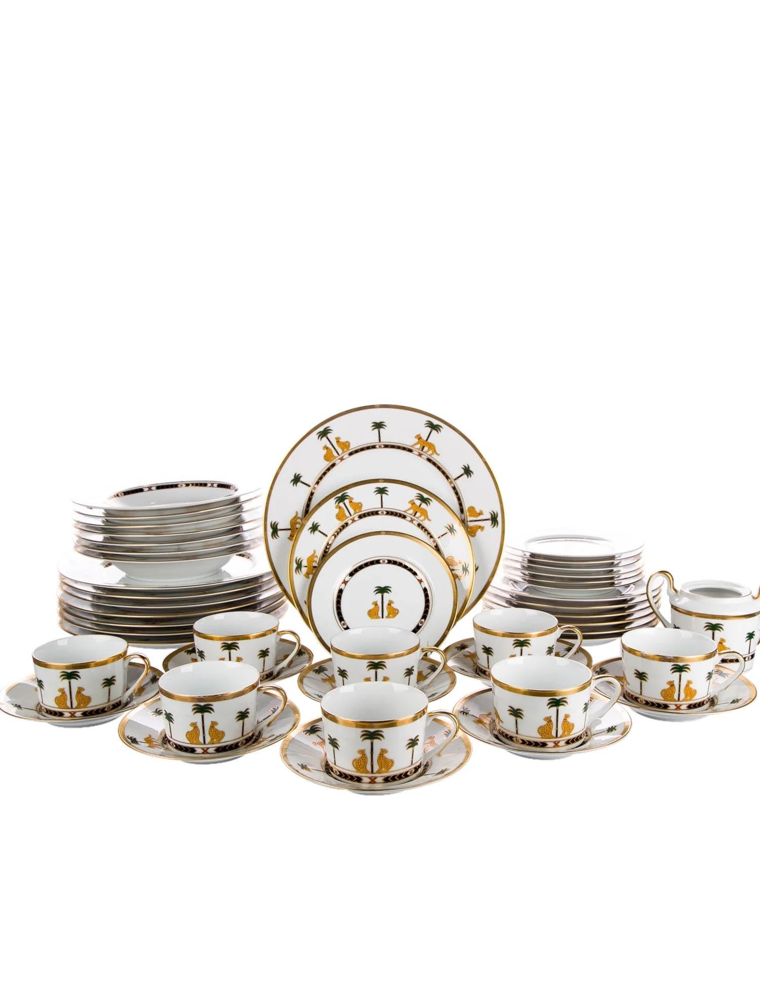 A set of four (4) place settings (16 total pieces) in the signature Casablanca pattern by Christian Dior.

Features a white, gold and multicolor pattern with panther and palm tree motifs throughout, gilt accents throughout and brand stamp at