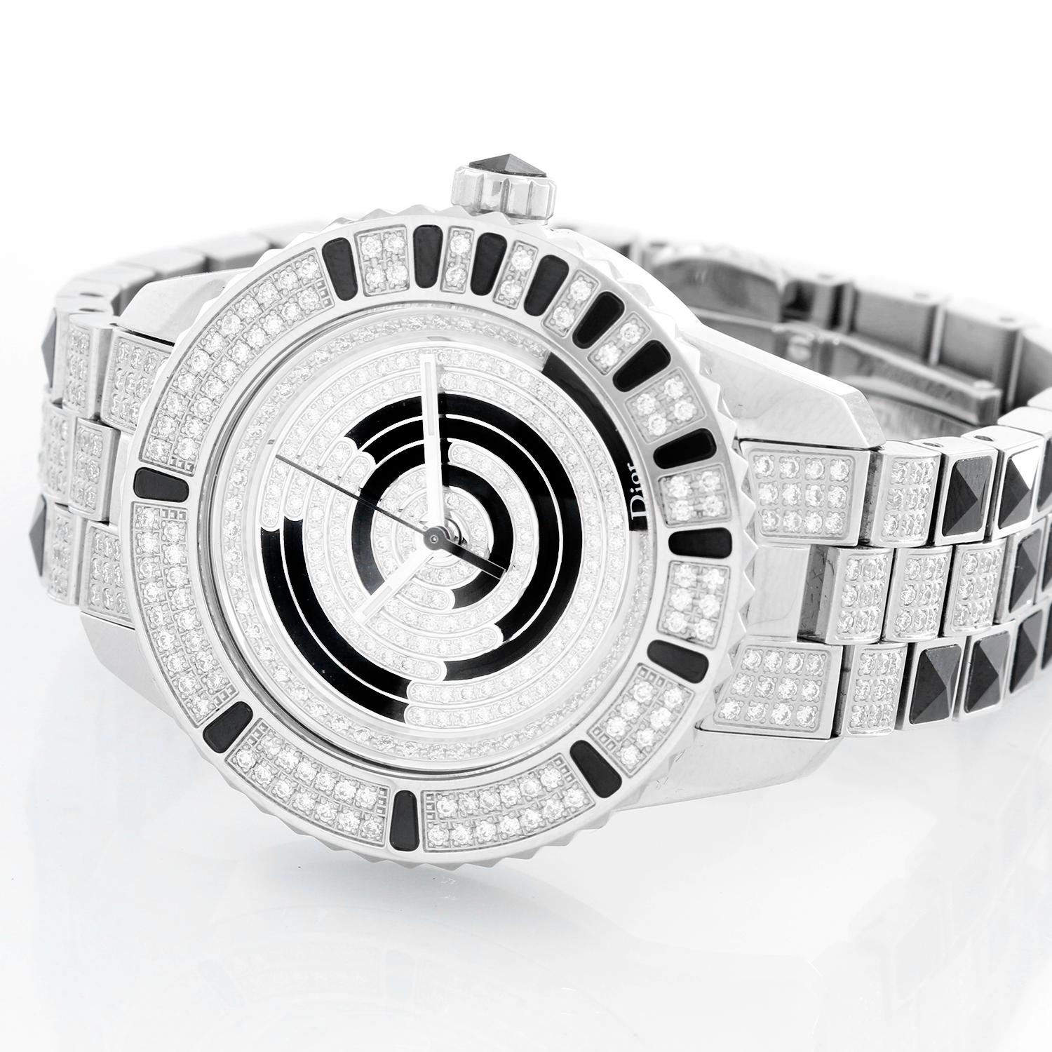 Christian Dior Christal Diamond Ladies Watch - Quartz. Stainless steel case (33 mm)  with pave diamonds and gemstones. Diamond and black gemstones dial. Pave diamond bracelet with double deployant clasp; will fit a 6 1/4 inch wrist. Pre-owned with