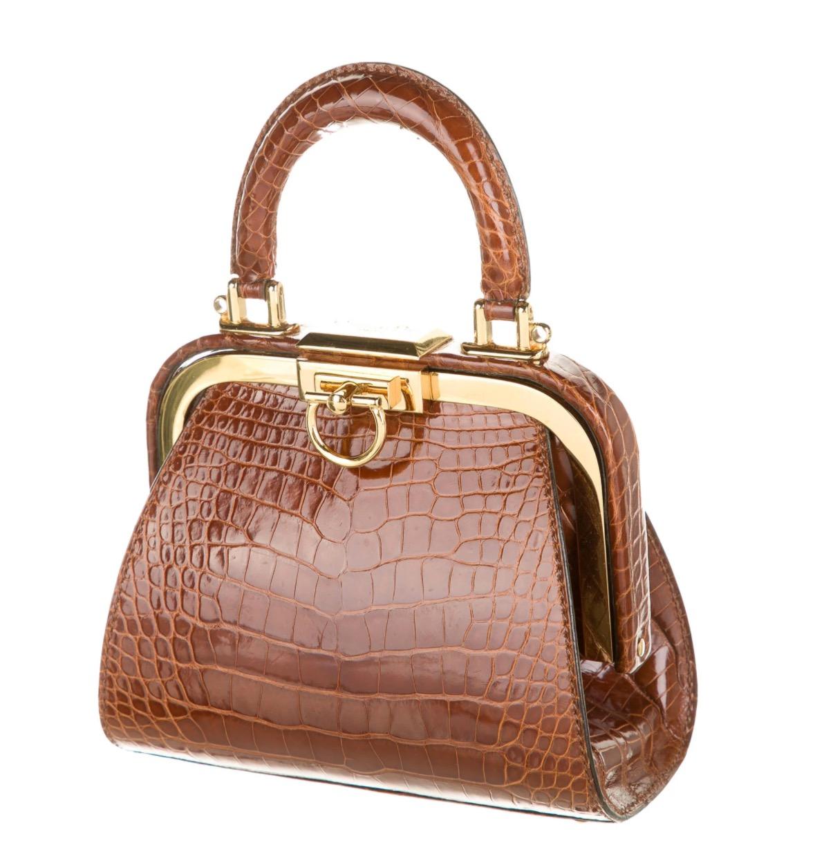Alligator
Gold-tone hardware
Leather lining
Push-lock closure 
Shoulder strap drop 23.75