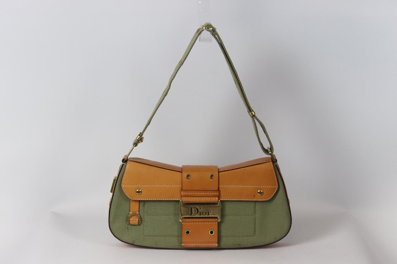 Christian Dior Columbus canvas and leather shoulder bag. Khaki and tan. Magnetic snap fastening at front. Protective plastic attached to hardware. Comes with authenticity card. Does not come with dustbag or box. Height: 6.5 in. Width: 12 in. Depth: