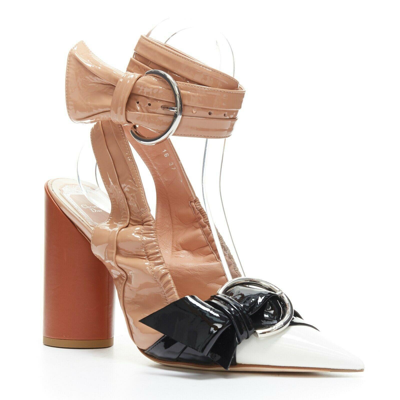 CHRISTIAN DIOR Conquest tri-toned patent buckle point toe cylinder heels EU37
CHRISTIAN DIOR BY RAF SIMONS
Dior Conquest. 
Triple toned patent leather. 
Nude, black and white. 
Silver buckle details. 
Brown cylinder heels. 
Leather insole and sole.