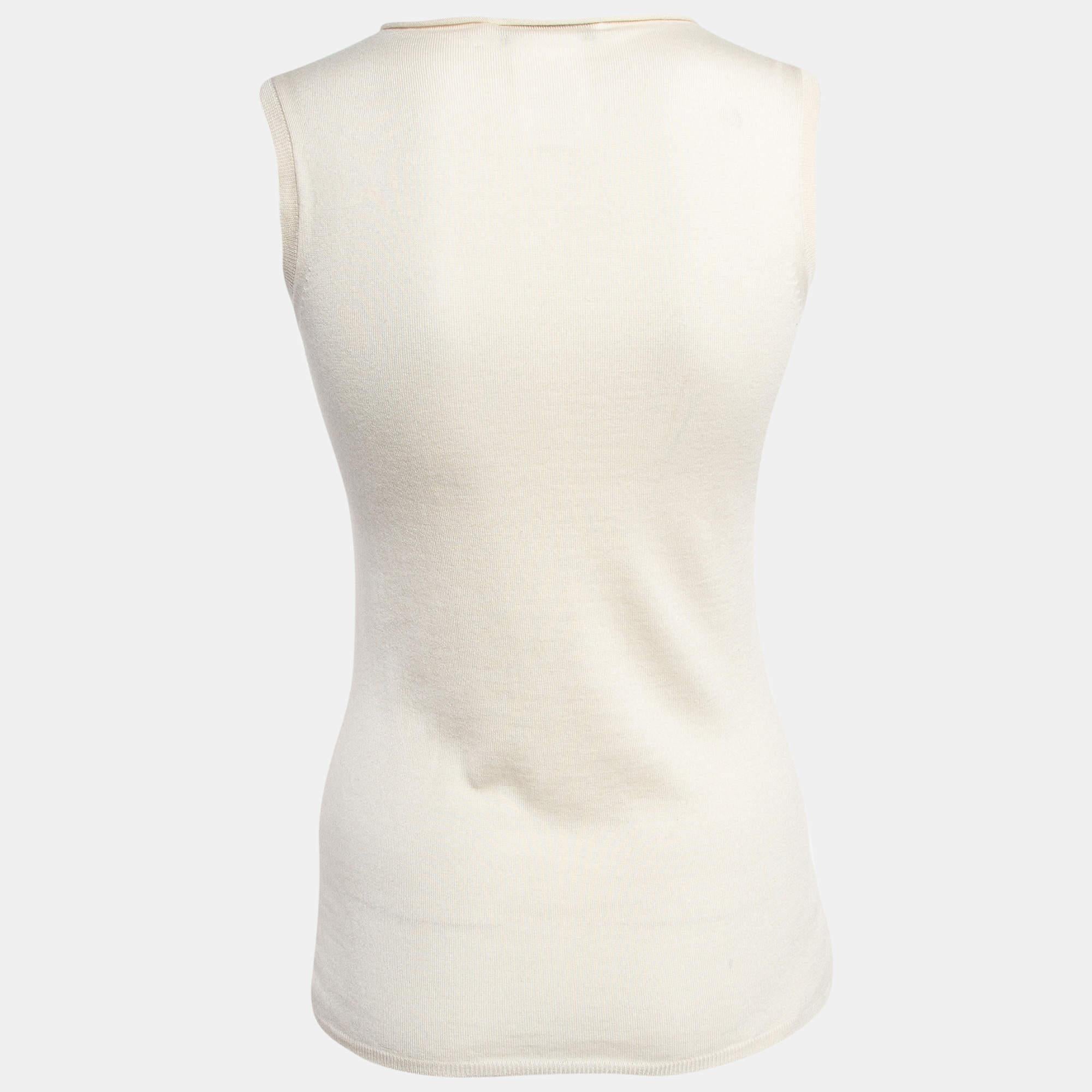 Wrap yourself in the luxurious comfort of the Christian Dior top. Crafted from sumptuously soft cashmere, this sleeveless top features a sophisticated rib knit design and a raw edge neckline, exuding effortless style and understated elegance for any