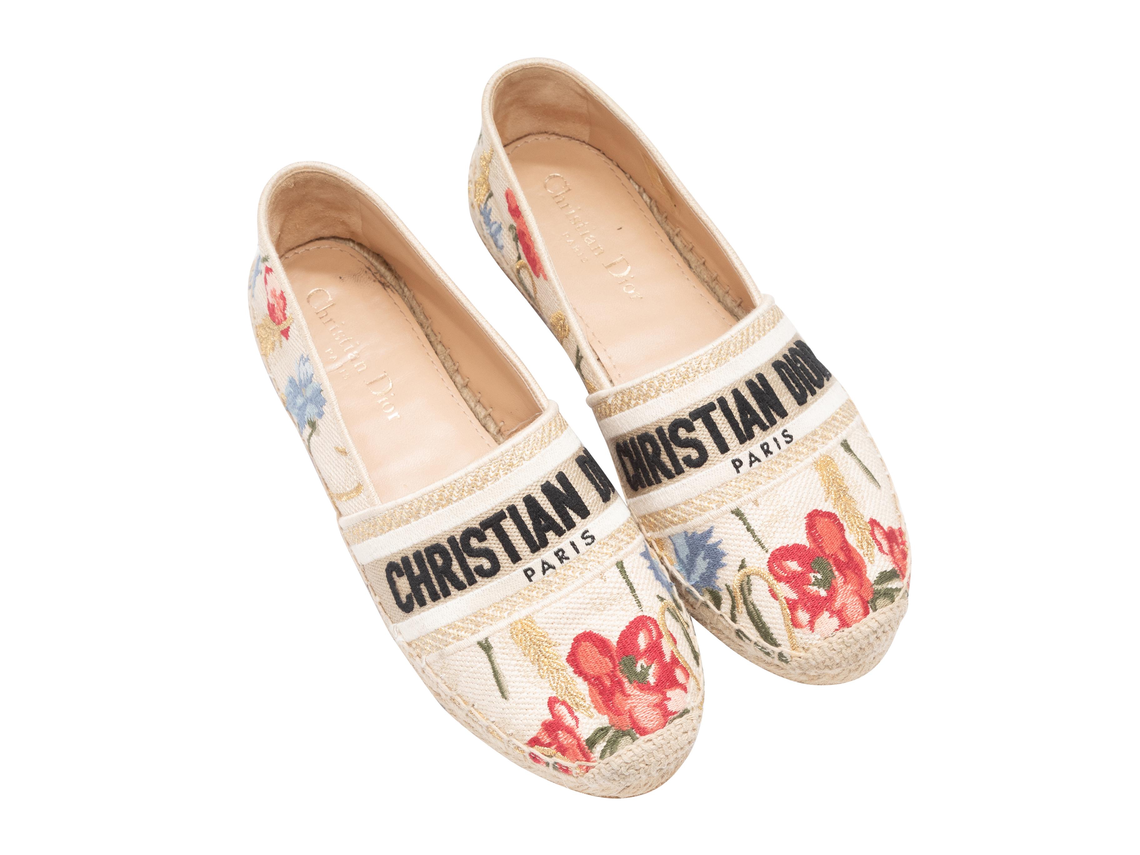 Product Details: Cream and multicolor floral embroidered espadrille flats by Christian Dior. Jute trim at soles. 1
