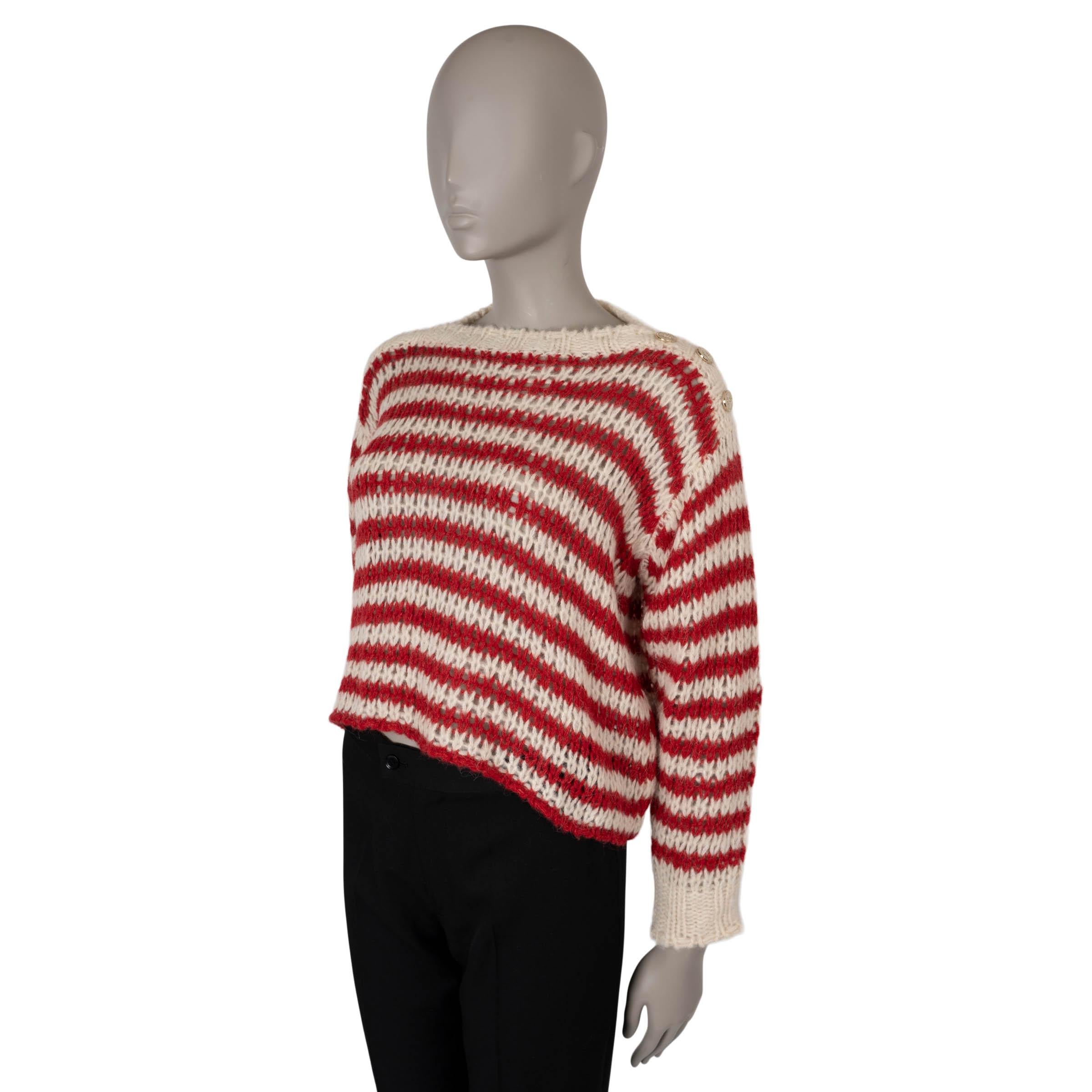 This 100% authentic Christian Dior Marinière sweater is crafted from a luxurious blend of cream and red striped loose-knit alpaca (40%), cashmere (30%), and silk (30%). It features a cropped, boxy silhouette with a classic boat neck adorned with