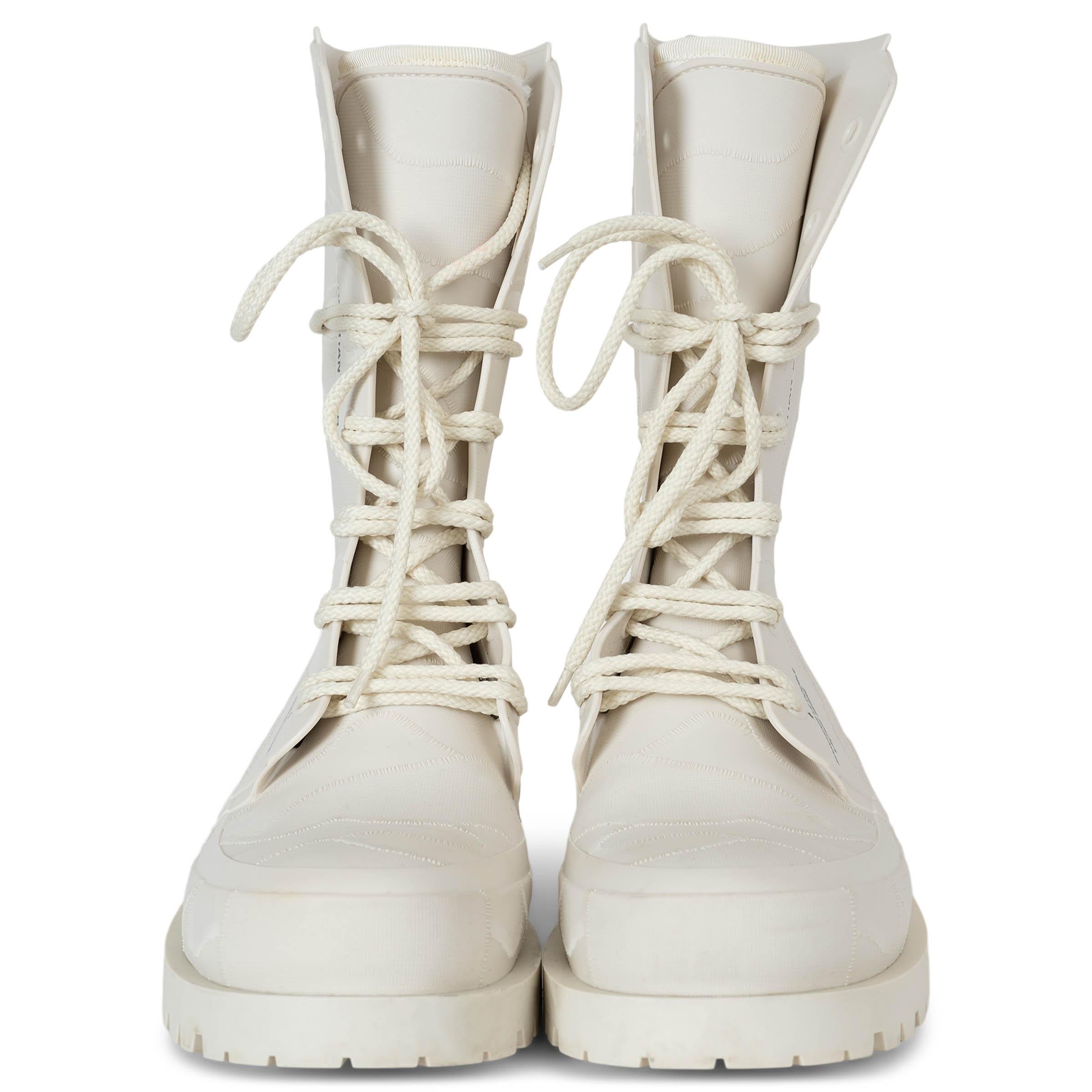 Questi stivali Christian Dior DiorCamp 100% autentici in gomma color crema con texture mimetica offrono una rivisitazione moderna dello stile utilitaristico. Caratterizzate da gambo a metà polpaccio, punta tonda e spessa suola in gomma con un