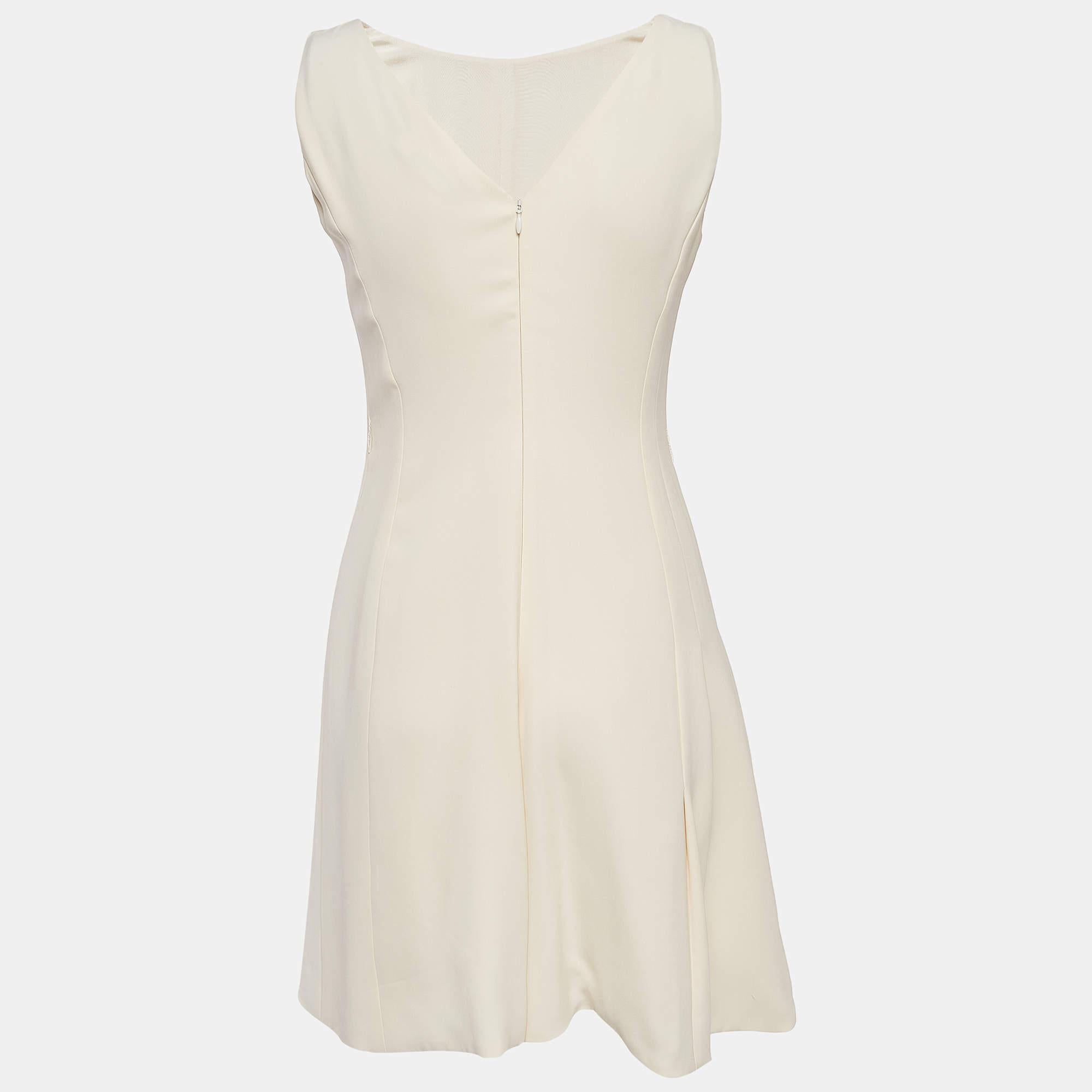 Experience effortless chic with the Christian Dior playsuit. Crafted with meticulous attention to detail, this playsuit features a luxurious cream silk fabric and sophisticated paneled design, exuding timeless style. Perfect for any occasion, it