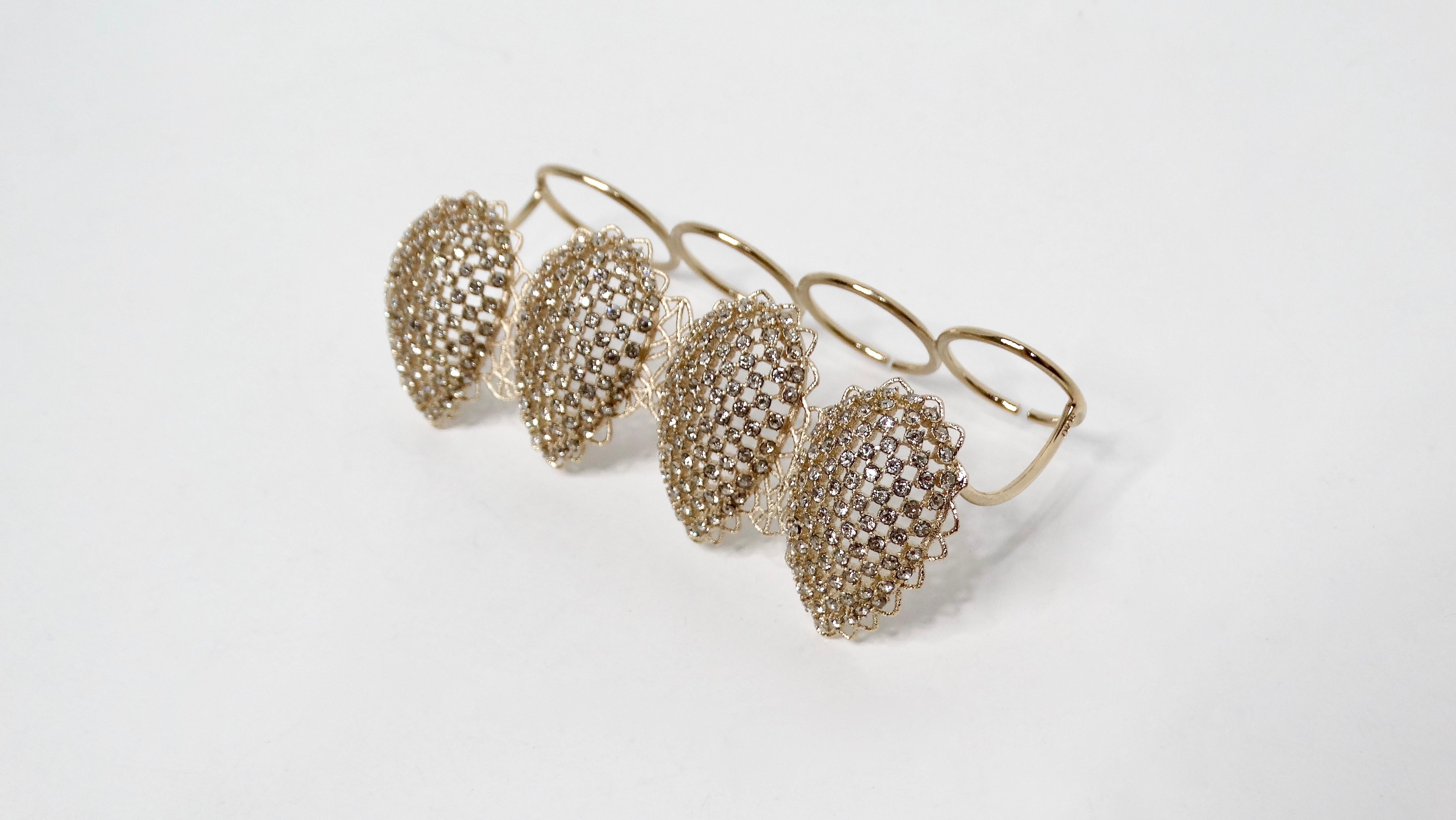 The Christian Dior Crystal Mesh Gold-Tone Four-Finger Statement Ring is a bold piece of costume jewelry designed to make a statement. Crafted with a gold-tone finish, this ring features a unique four-finger design, with each finger adorned with an