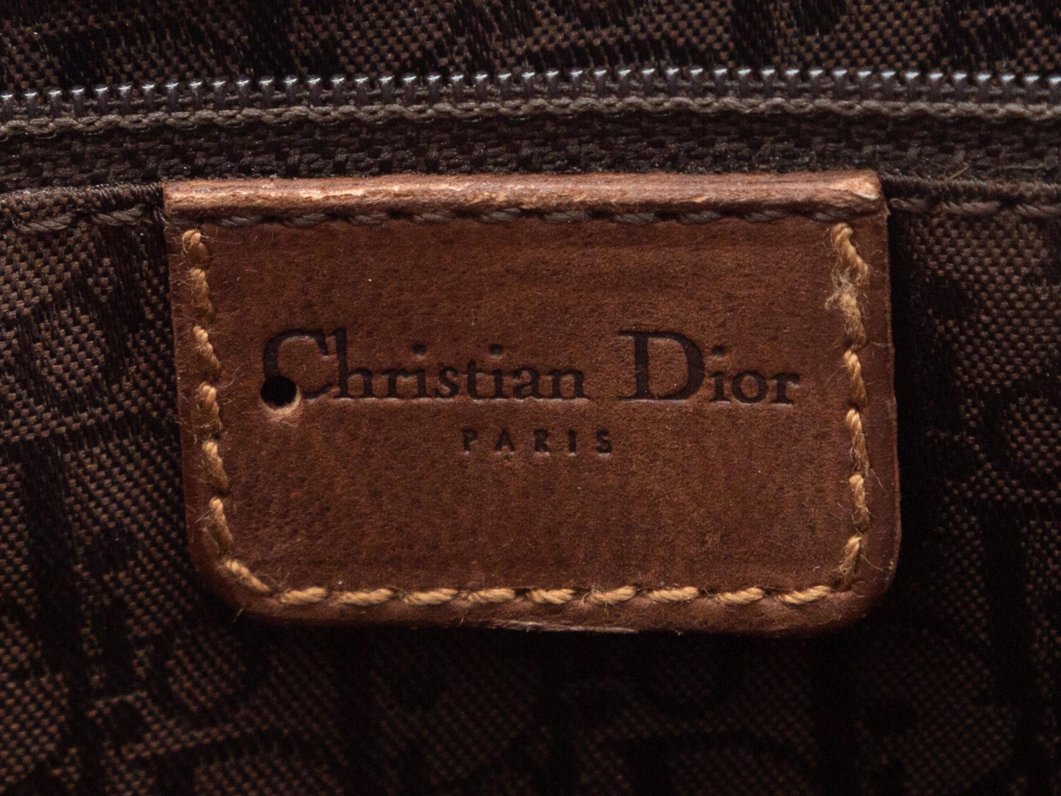 Product Details: Dark Blue & Brown Christian Dior Denim 2002 Handbag. This bag features a denim body, leather trim, gold-tone hardware, Oblique lining, dual top handles, and a zip closure at the top. 17