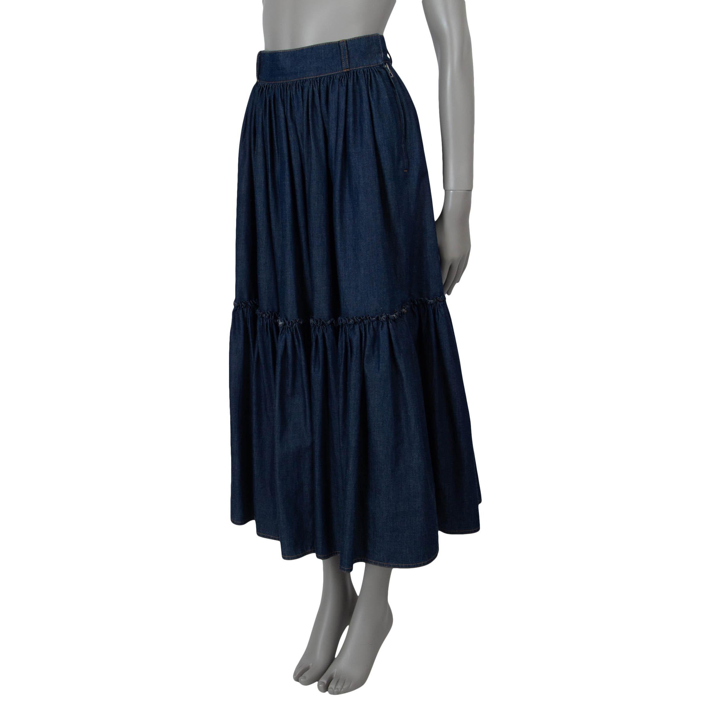 This 100% authentic Christian Dior Denim Couture prairie skirt in dark blue denim cotton (100% - please note the size and content tag are missing) embodies effortless elegance. Designed with a flared, midi-length silhouette, it features a gathered