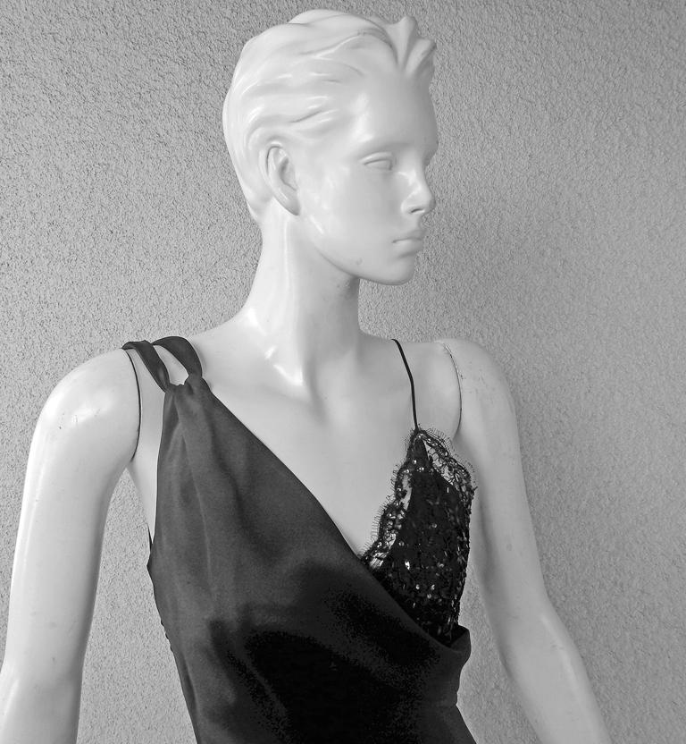Christian Dior rich black silk charmeuse bias cut gown.   Spaghetti straps.   A portion of bodice in scalloped beaded lace.   Covered silk buttons on side entry.  Fits elegantly and gracefully on the body.   A 'little black dress' definitely a