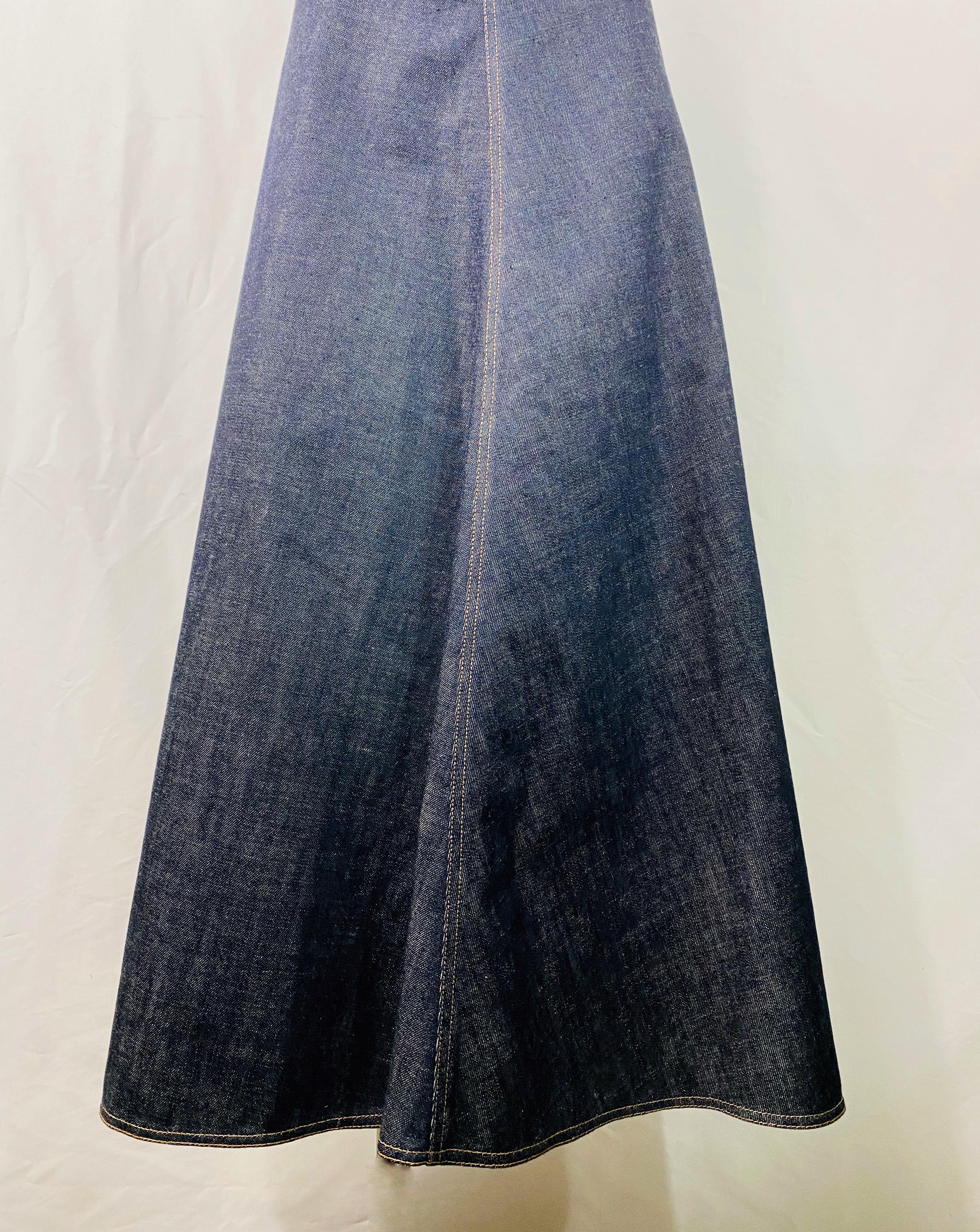 Product details:

Size FR 38, US6.
Featuring dark blue/ navy wash denim, flare style, floor length skirt with rear hook and zip silver tone hardware stamped CD closure.
Made in Italy.
