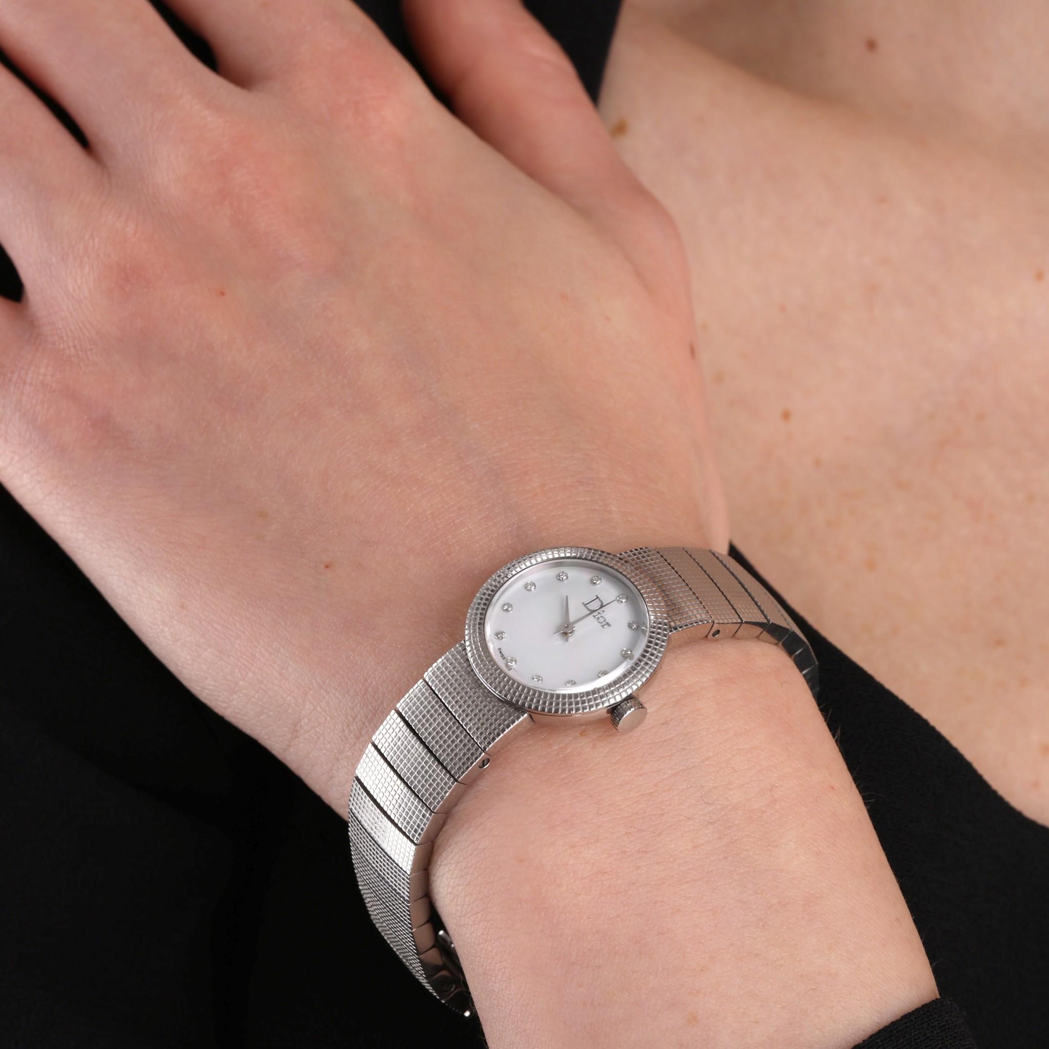 Christian Dior Diamond Dot Dial & Mother Of Pearl Baby D Watch

Mother of pearl dial with diamond dot hour markers.

Stainless steel case and strap with deployment buckle closure, quartz movement.

Size - 23mm

Condition - Good/Very Good (Some