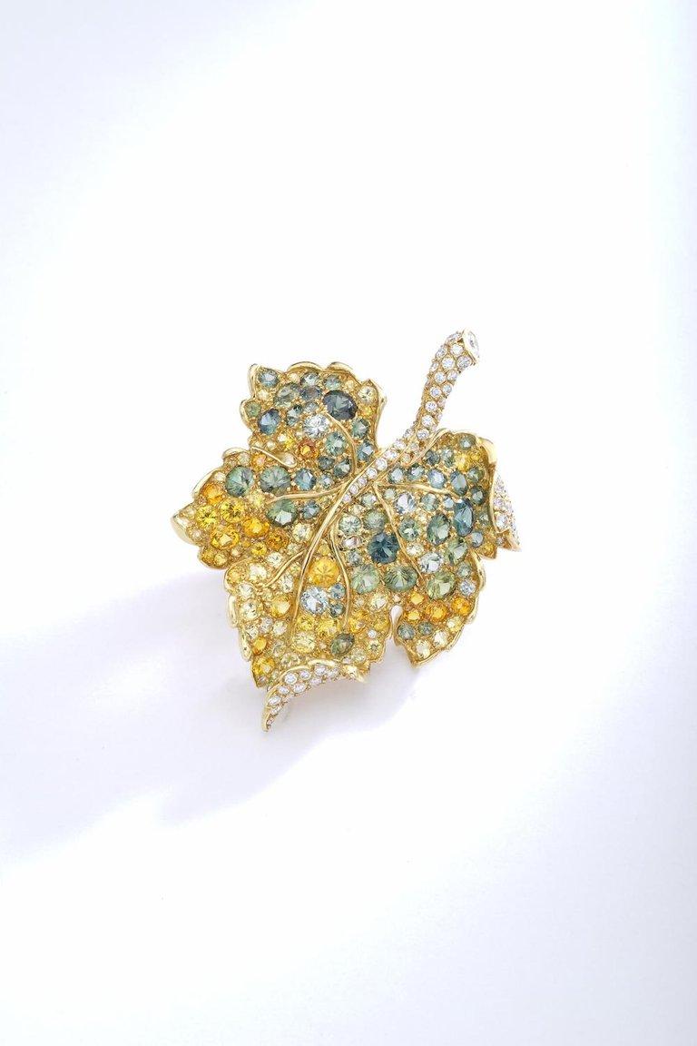 From a French famous Lady established in Switzerland this 18 Karat Two-Color Gold, Diamond and Colored Sapphire Leaf Brooch, Christian Dior, France is as amazing as a master painting.

Designed as a leaf, the body composed of round diamonds, further