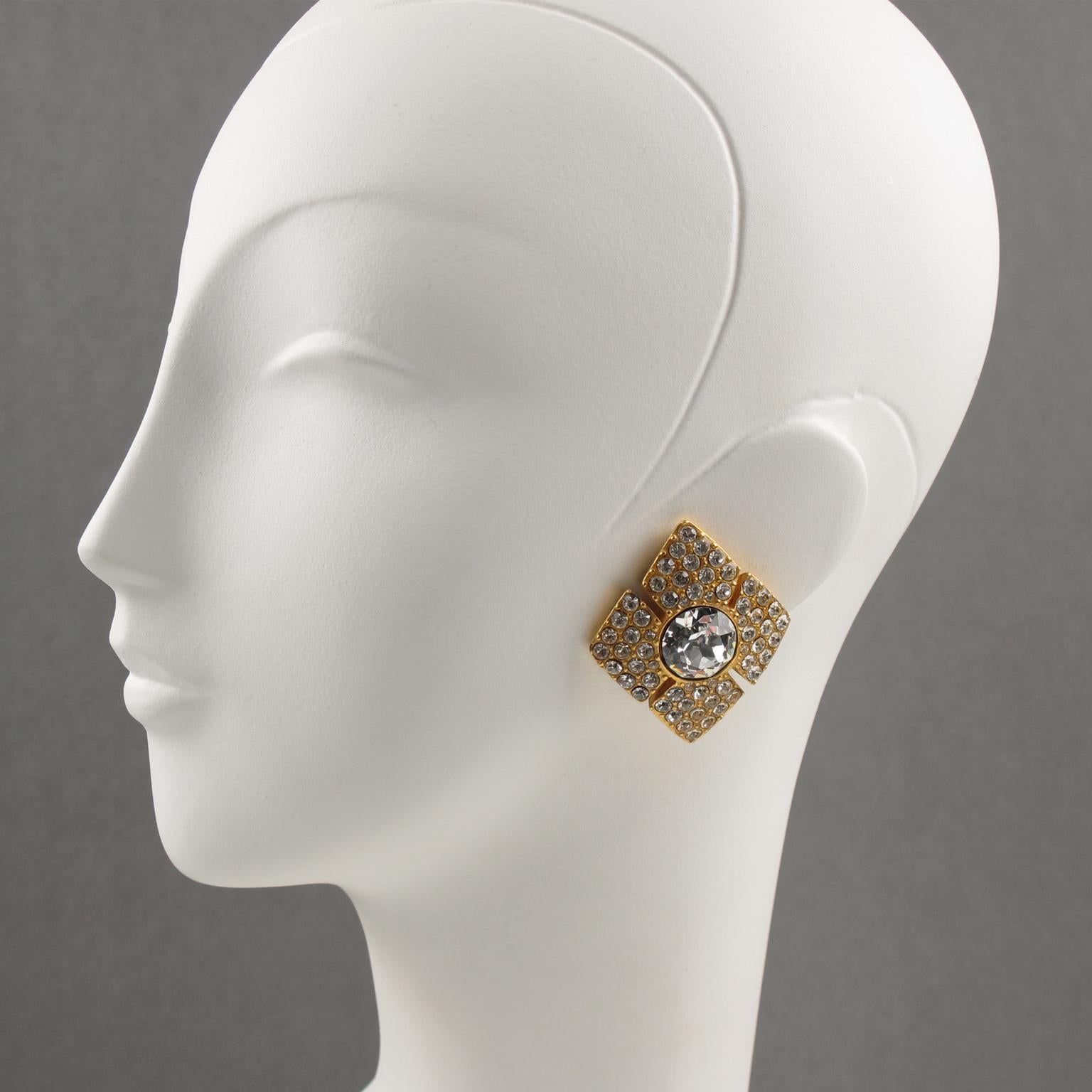 These elegant Christian Dior Paris clip-on earrings boast a diamond-shaped design, all paved with tiny crystal rhinestones and topped in the center with a larger faceted crystal rhinestone. The earrings are marked underside with the Christian Dior