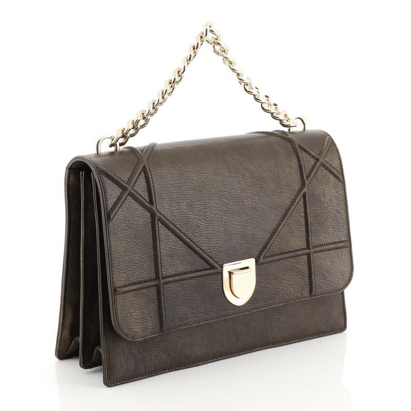 This Christian Dior Diorama Chain Satchel Grained Leather Large, crafted from brown grained leather, features chain link strap and gold-tone hardware. Its slide-press closure opens to a gold fabric interior with a center zip pocket and side slip