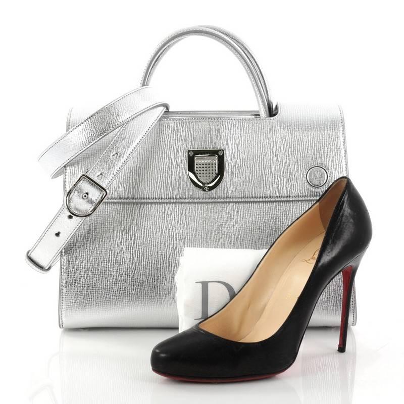 This authentic Christian Dior Diorever Top Handle Bag Leather Medium is both bold and beautiful, perfect for every fashionista. Crafted from metallic silver leather, this bag features dual-rolled leather handles, side snap buttons, protective base