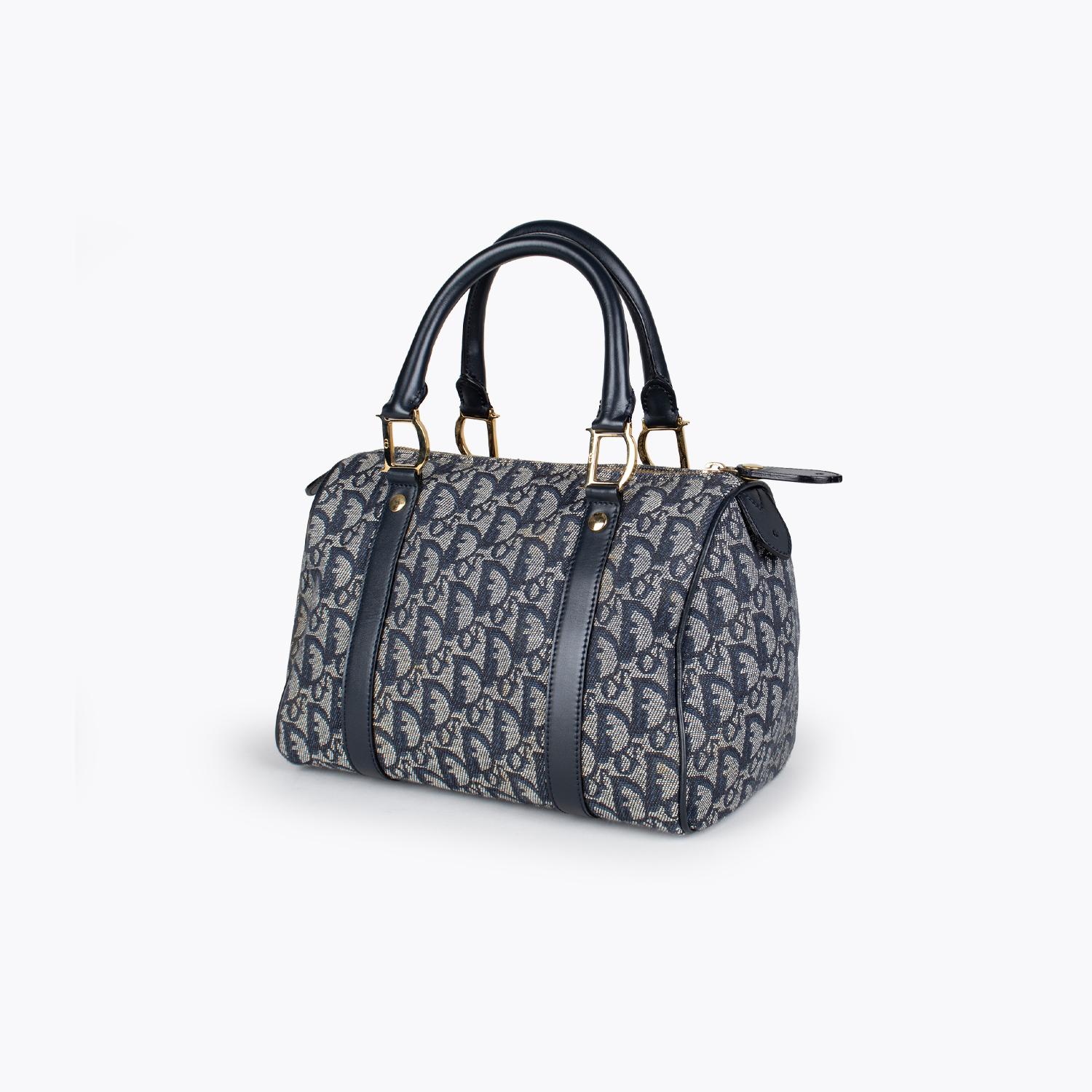 Navy and tan Diorissimo canvas Christian Dior Boston bag

- Gold-tone hardware
- Navy leather trim
- Dual rolled top handles
- Tan interior lining, single zip pocket at interior wall and zip closure at top

Overall Preloved Condition: Very