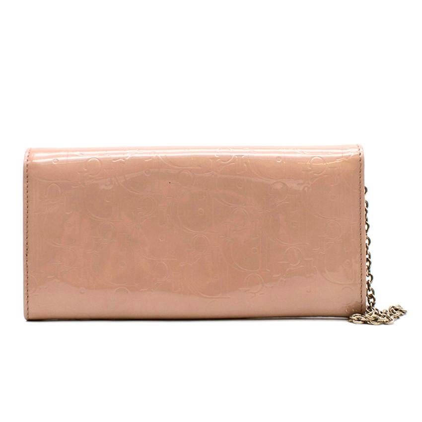 Christian Dior Pink Diorissimo Patent Leather Chain Wallet 

- Pink, patent leather
- Front flap with push button
- Logo embossed
- Silver tone hardware
- Single chain-link top handle
- Tonal leather lining
- Dual interior compartments
- one zip