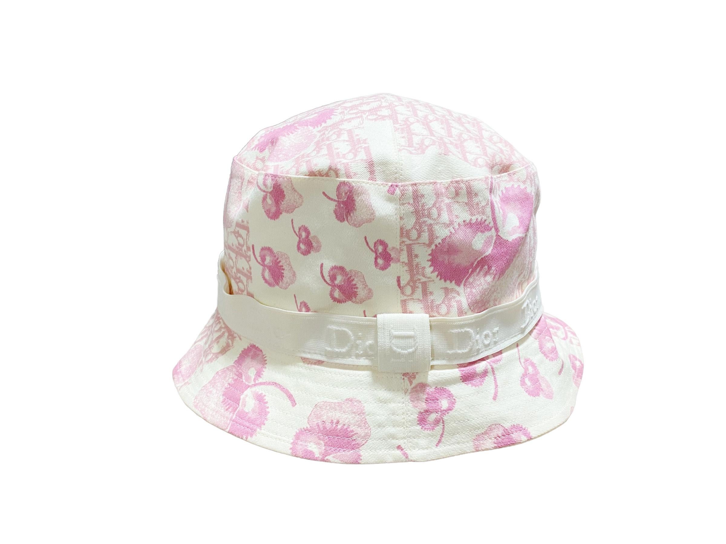 Diorissimo Resort 2005 Logo Flowers Bucket Hat. Pink and white bucket hat adorned with a logo flowers Diorissimo print from the resort 2005 collection by John Galliano for Christian Dior. Unique and one of a kind piece + Sold out everywhere!