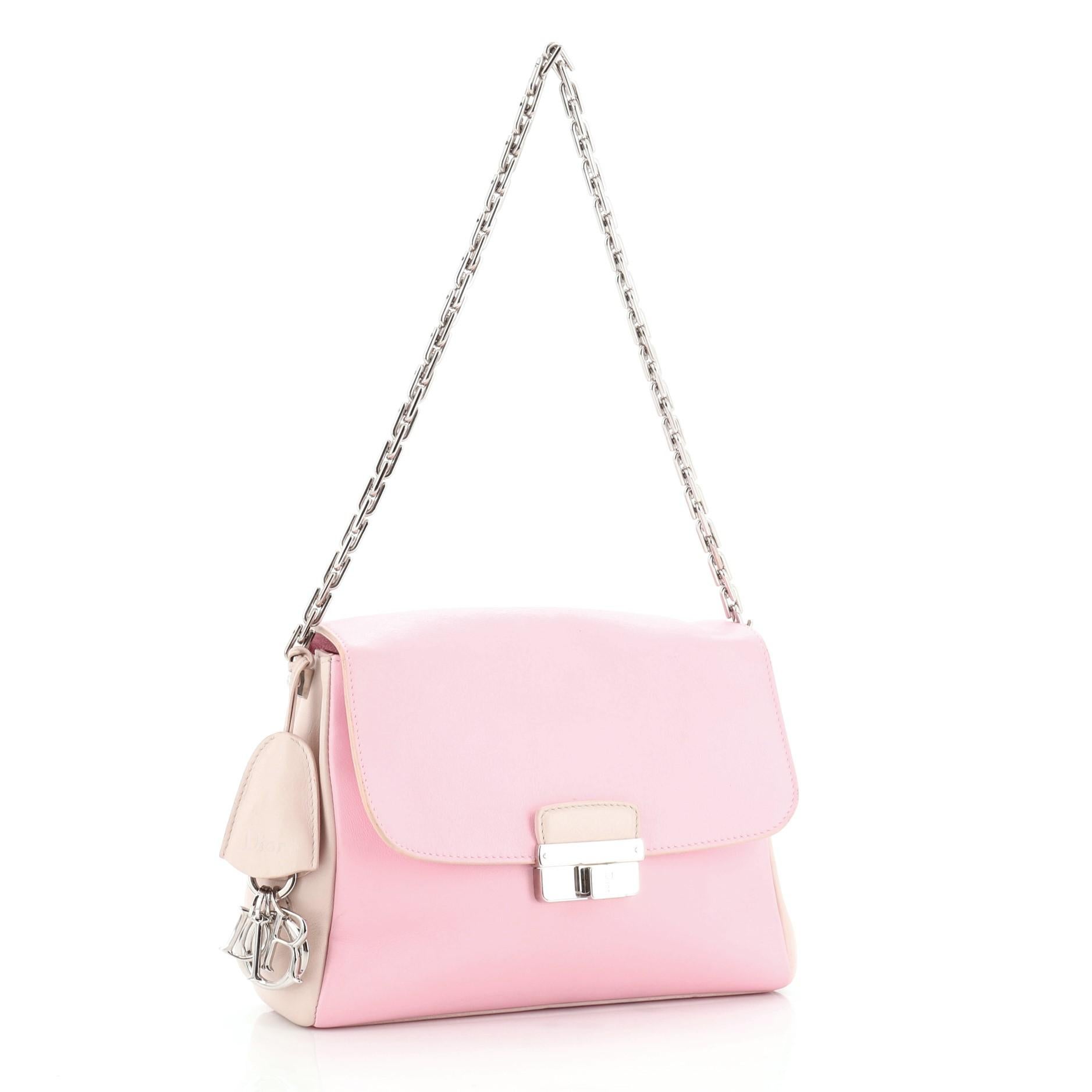 This Christian Dior Diorling Shoulder Bag Leather Large, crafted from pink neutral multicolored leather, features chain link shoulder strap, exterior back pocket, and silver-tone hardware. Its push-lock closure opens to a pink leather interior