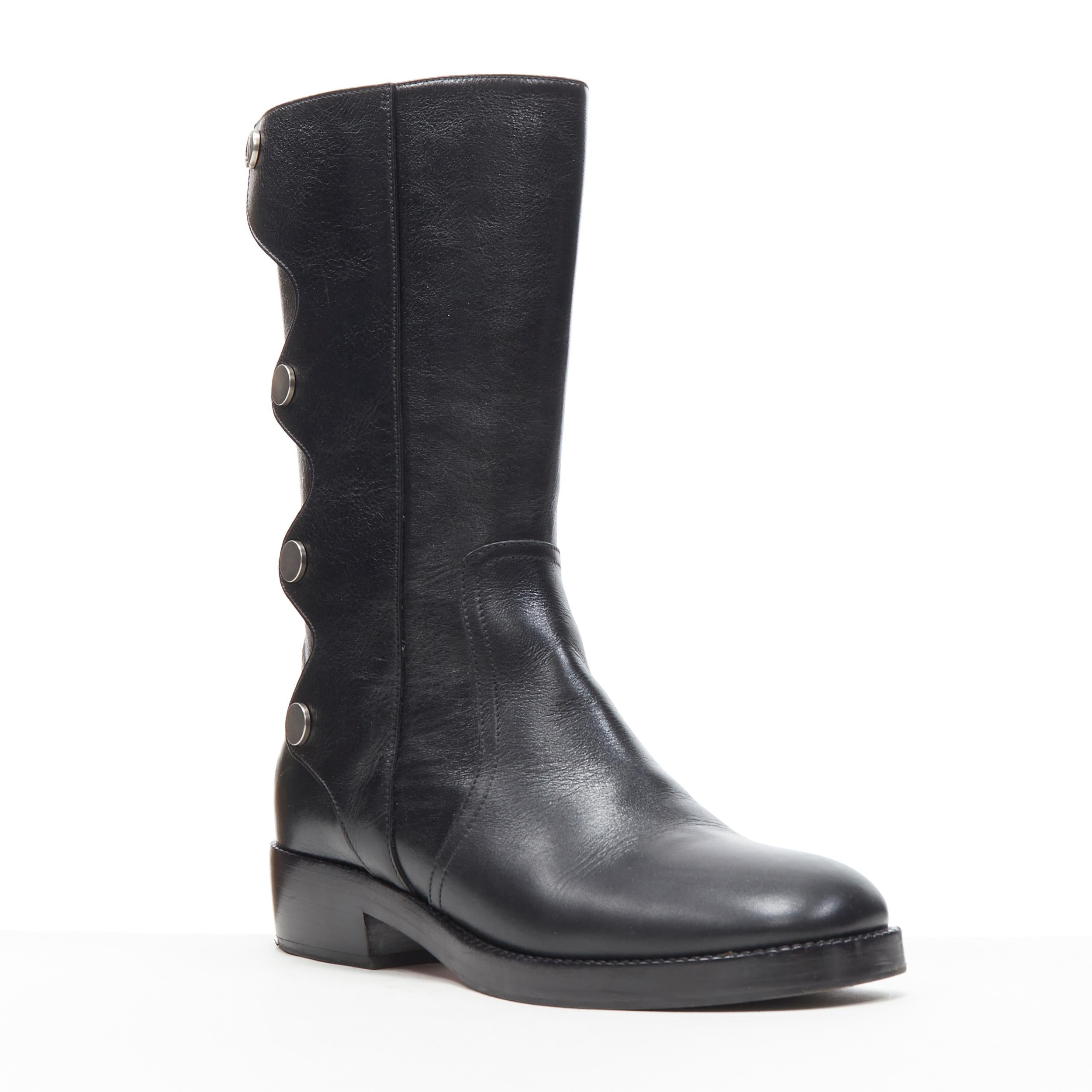 CHRISTIAN DIOR Diorodeo shiny calfskin leather tall flat riding boot EU38 D 
Reference: AYYP/A00006 
Brand: Christian Dior 
Material: Leather 
Color: Black 
Pattern: Solid
Closure: Button 
Extra Detail: Diorodeo boots. Silver tone hardware. CD logo