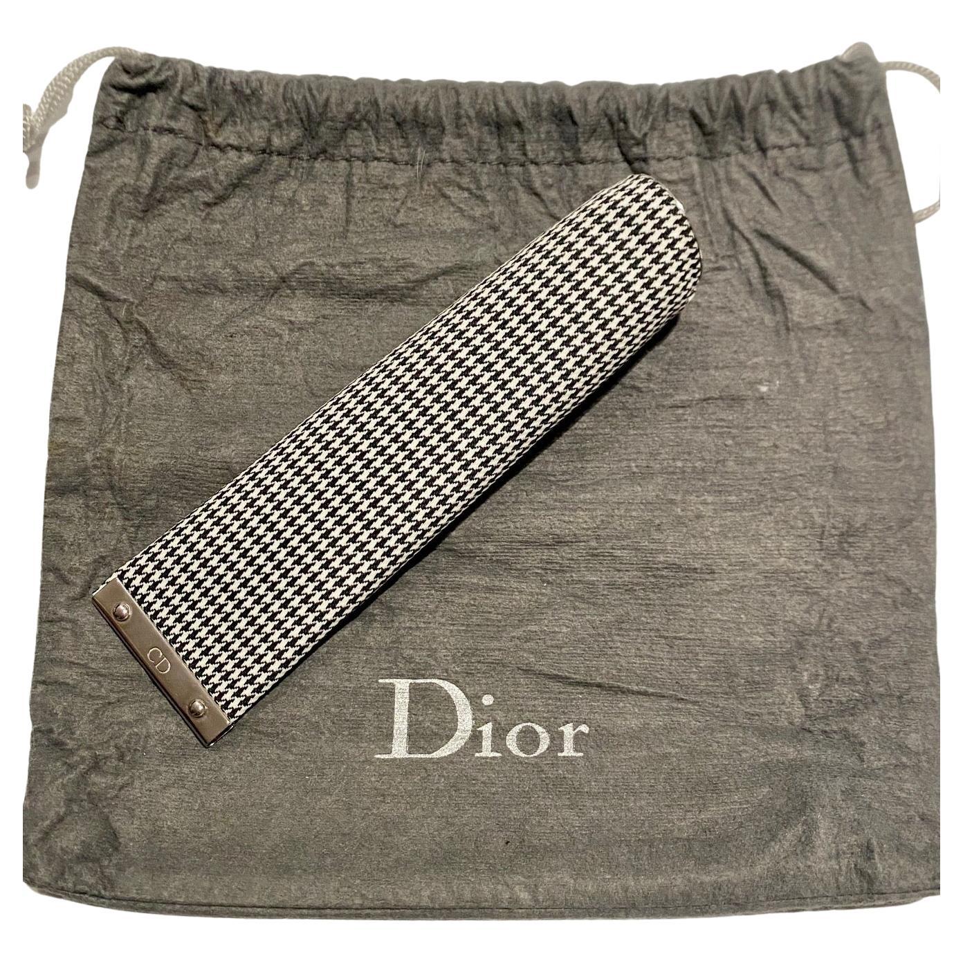 Christian Dior Dogtooth Toothpaste Tube Sleeve Cove, washable fabric, chrome clip at the bottom to release and insert tube; the sleeve cover securely contains the tube while providing a stylish touch to bathroom accessories. The clip feature aids in