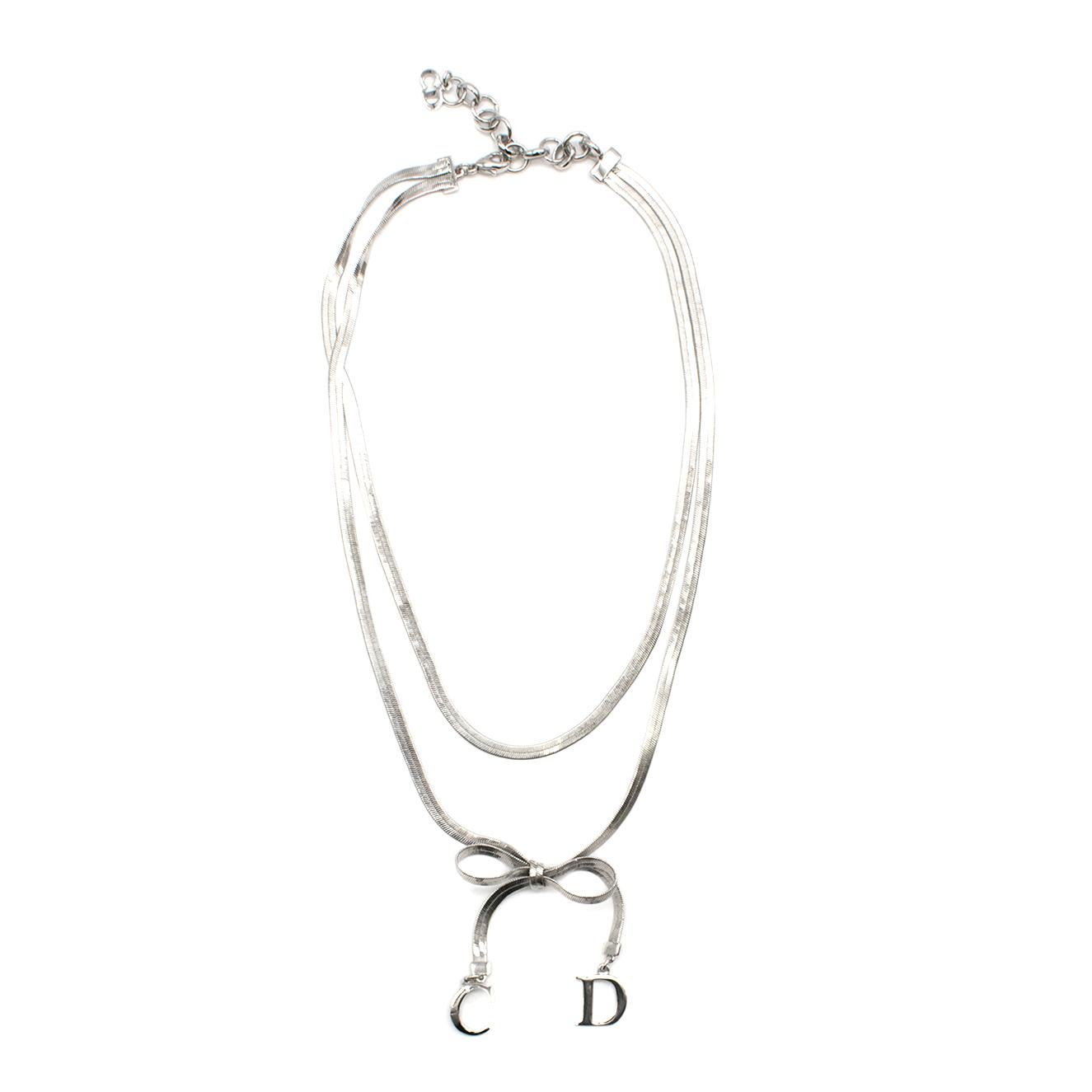 Christian Dior Silver Tone Double Chain Charm Necklace

- silver tone charm necklace 
- double chain 
- lobster claw fastening 
- bow detail to the bottom embellished with C & D

Please note, these items are pre-owned and may show some signs of