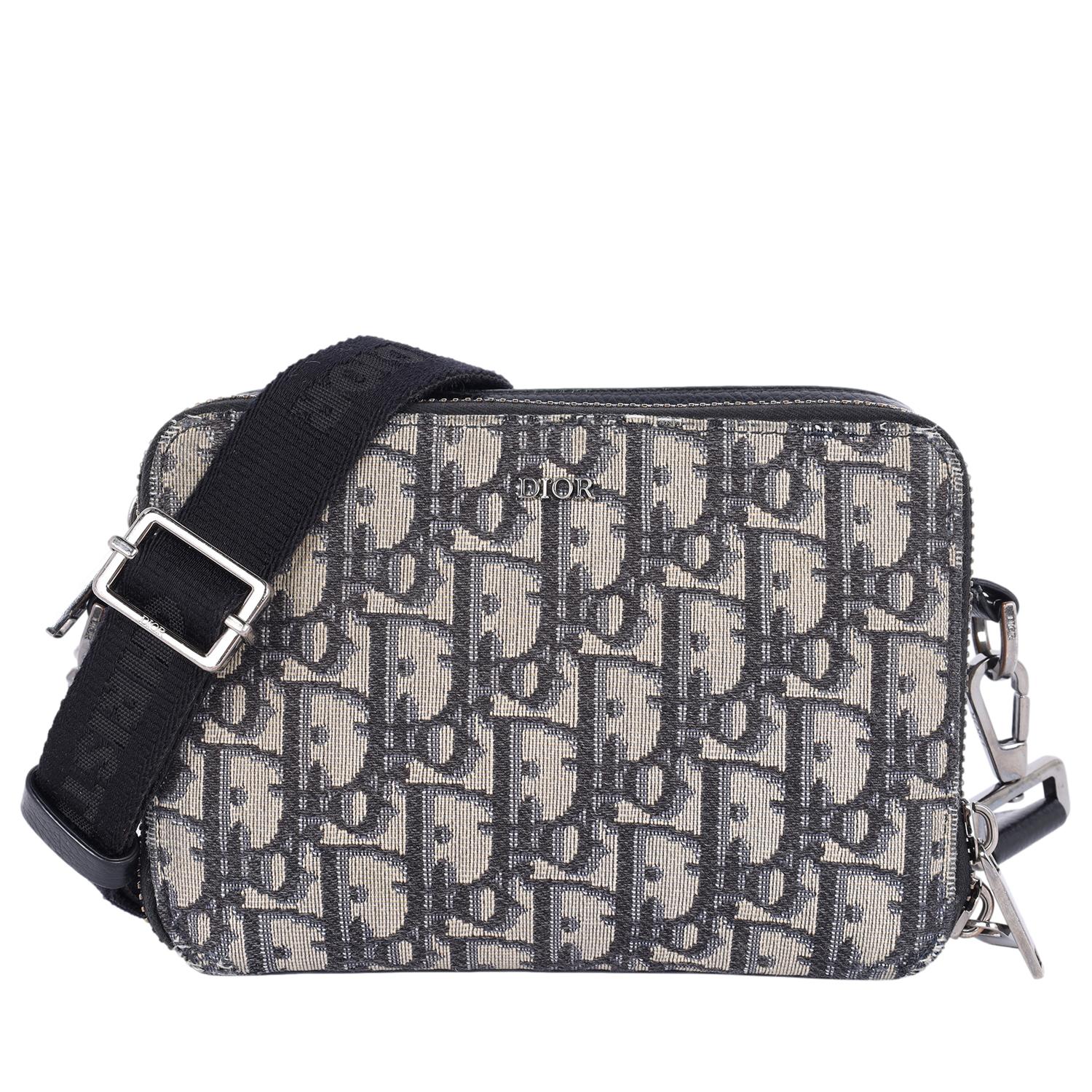 Authentic, pre-owned Christian Dior Double Zip Crossbody Pouch Oblique Canvas Crossbody Bag. 

Features navy blue, black on beige Dior monogram canvas. The bag features an adjustable black nylon shoulder strap, dual compartments with polished dark