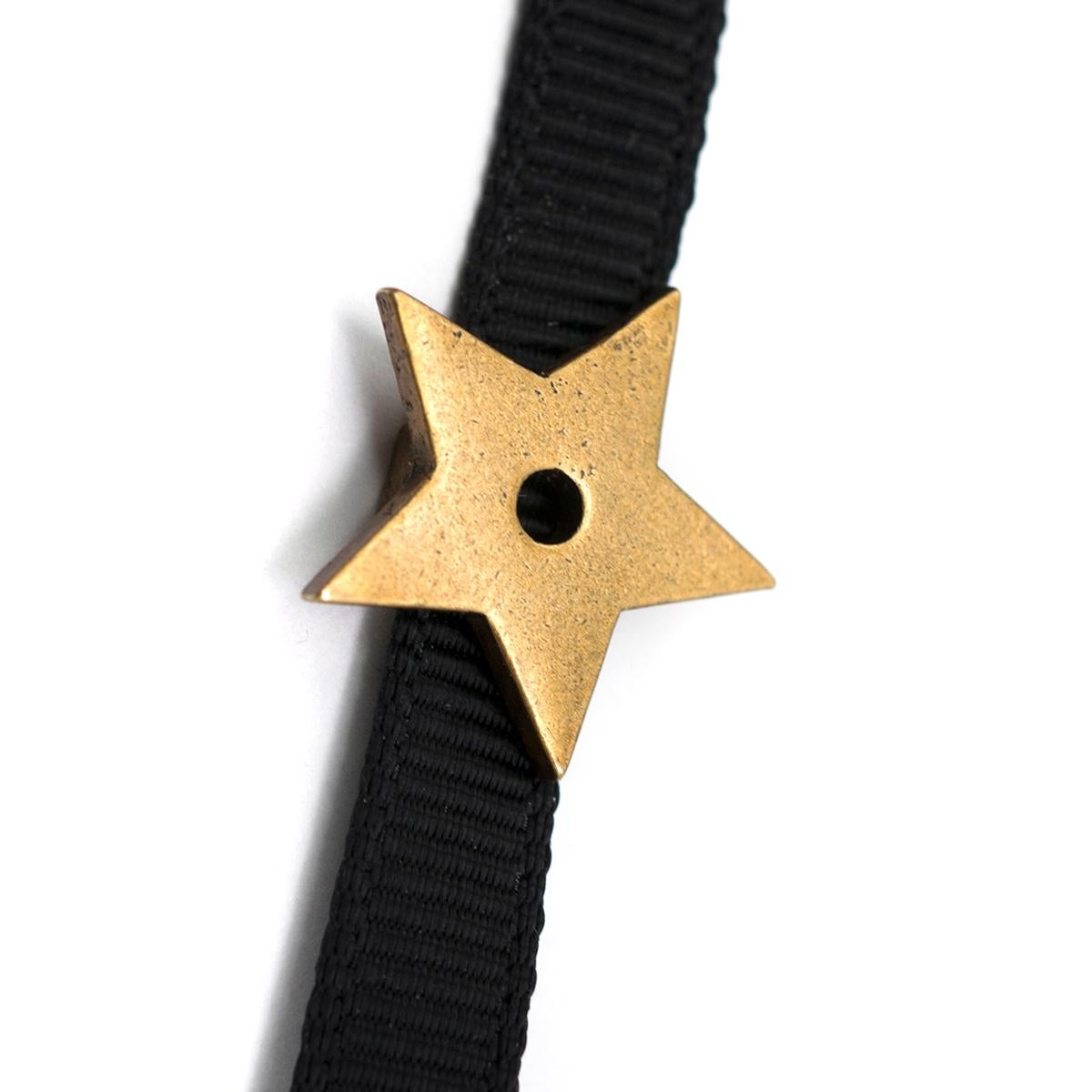 Christian Dior D'Porte-Bonheur Star Choker Necklace 

- Star Choker Necklace
- Gold-toned star pendant
- Black fabric ribbon cord
- Lobster clasp closure at back, adjustable length

Please note, these items are pre-owned and may show some signs of