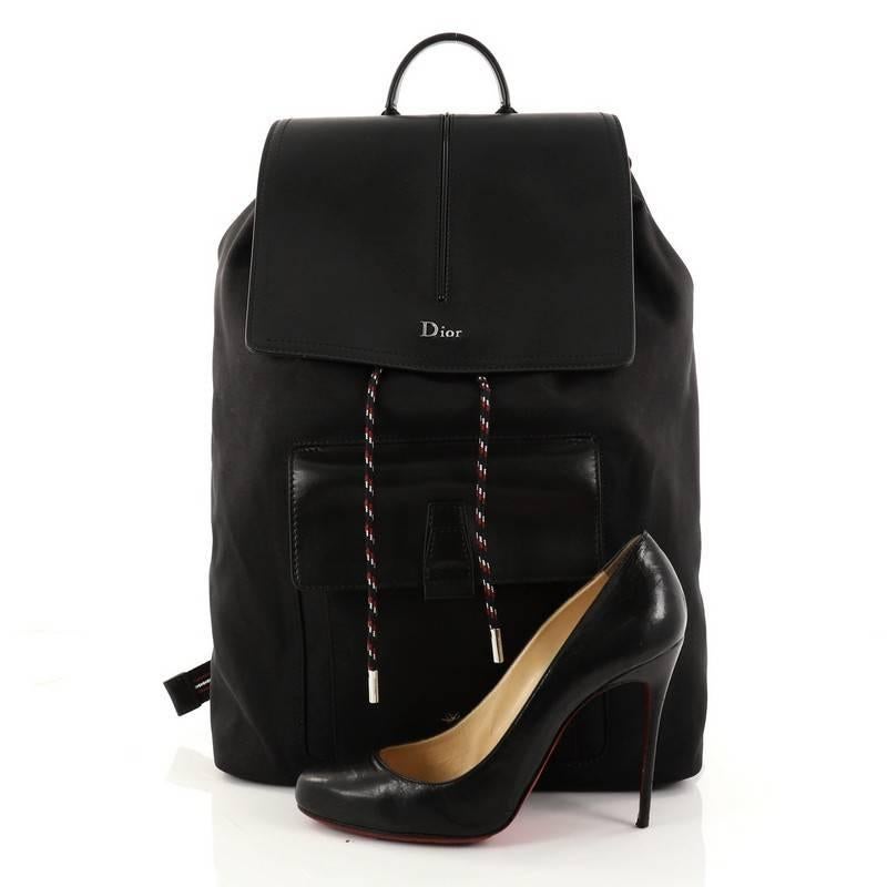 This authentic Christian Dior Drawstring Backpack Nylon and Leather from Dior Homme 2017 collection is a sophisticated backpack perfect for your on-the-go moments. Crafted in black nylon and leather, this stylish backpack features leather top