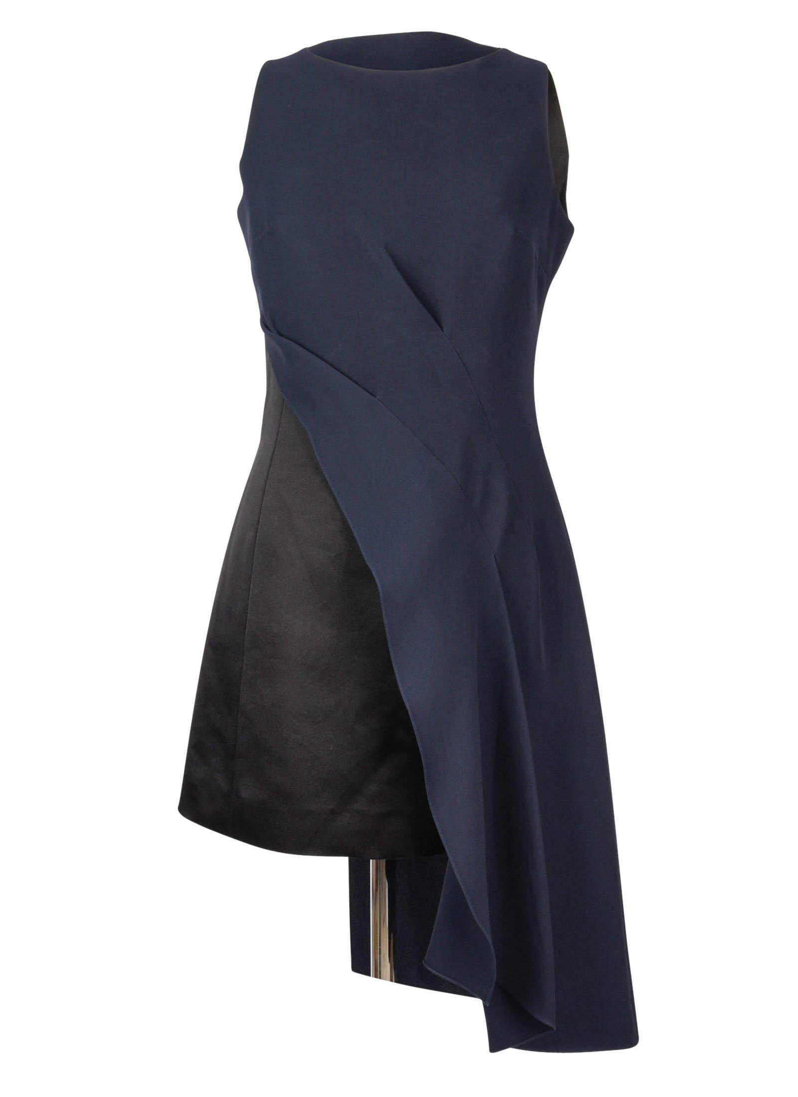 Guaranteed authentic Christian Dior black and navy asymmetrical dress with architectural detail.
Sleeveless black sheath with rear zip has an asymmetrical navy overlay.
A stunning dress with beautiful drape.
The overlay falls 9.5