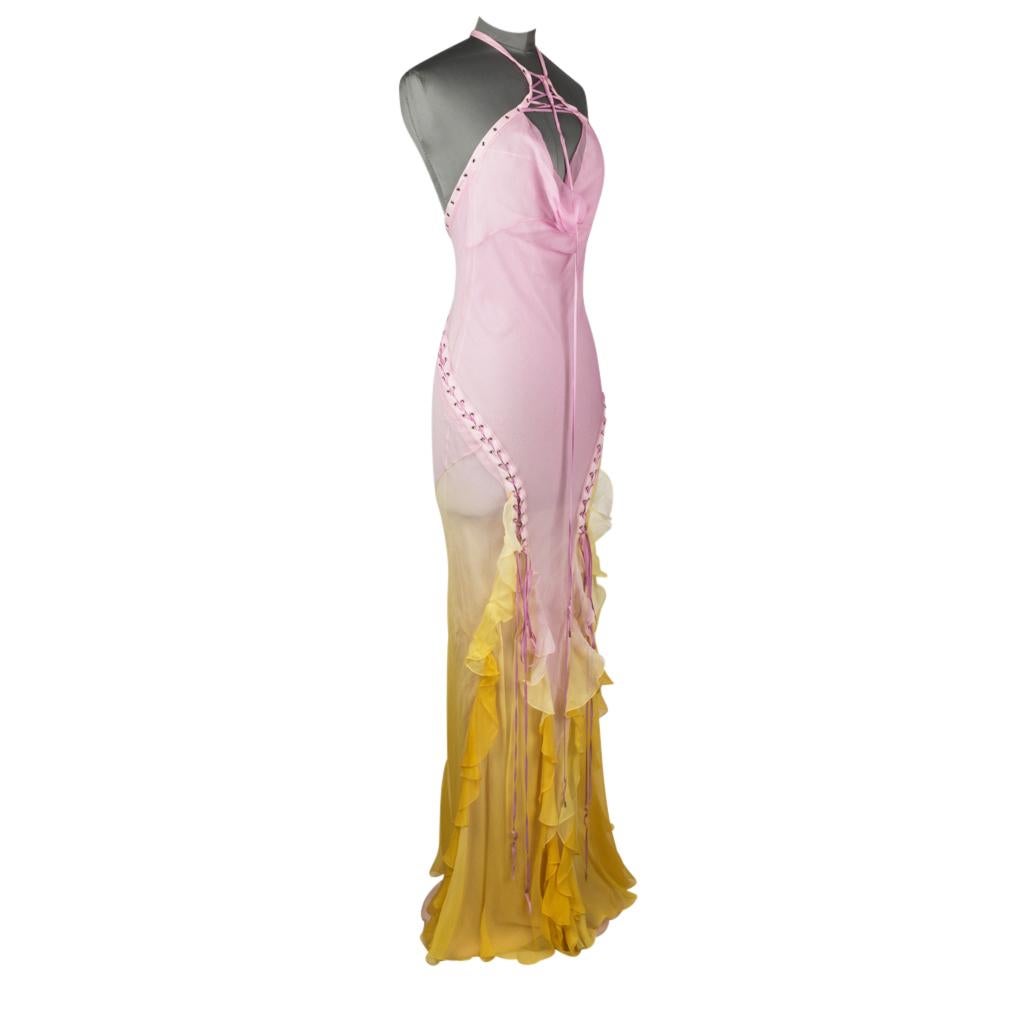 Guaranteed authentic Christian Dior long halter dress features lace up detail throughout.
Pale pink silk chiffon shades into pale to daffodil yellow.
Front is accentuated with ruffles from the top of the thigh down.
Open back.
This beauty is a show