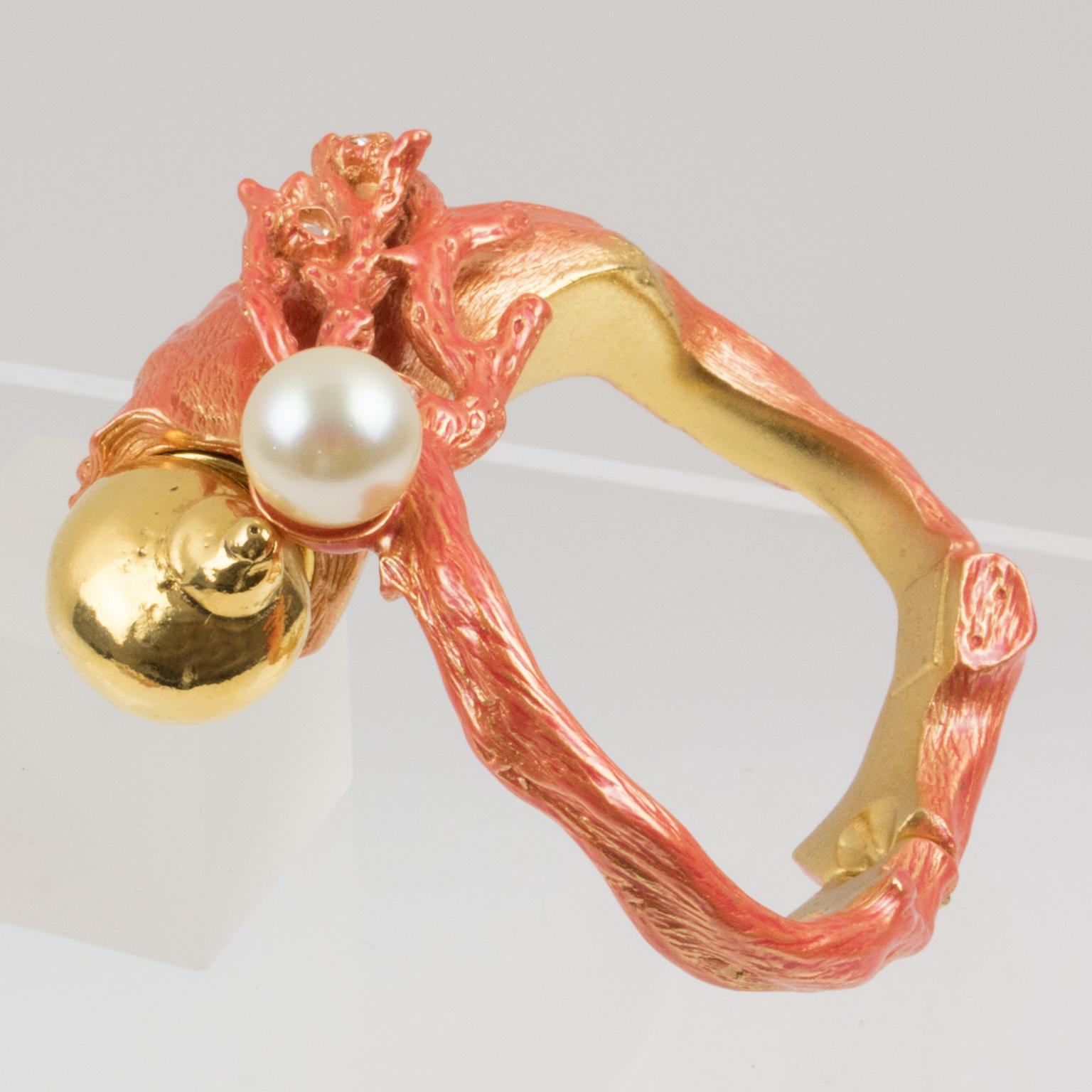 Stunning Christian Dior Paris signed clamper bracelet bangle designed for the launch of his Dune Fragrance in 1987. Sculptural coral branch dimensional design in gilt metal all textured with a bright orange enameling, topped with clear glass