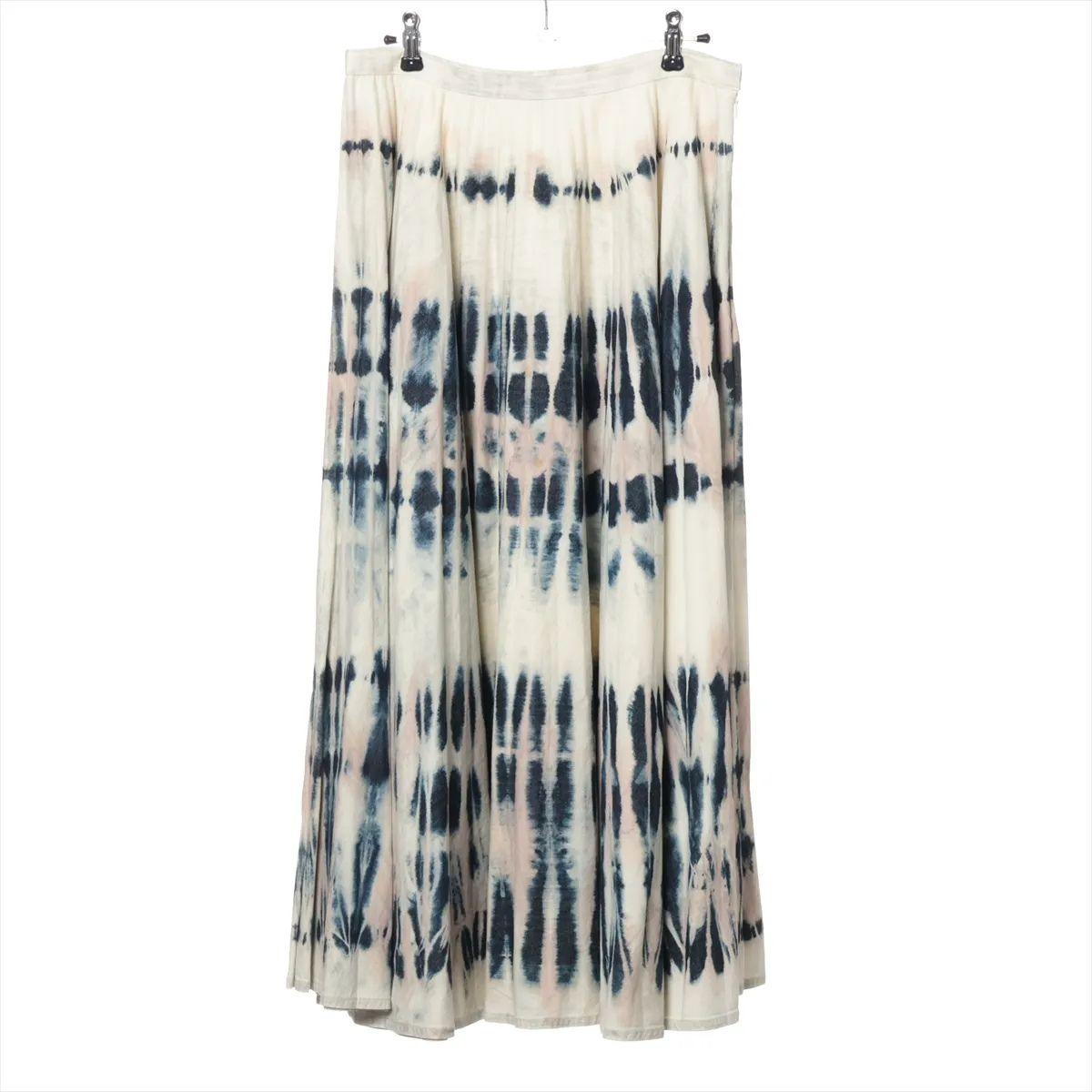 The Christian Dior Dye Cotton Skirt in Blue and White showcases a breezy, artistic flair with its soft gradient tie-dye effect. Crafted from lightweight cotton, the skirt offers a flowing silhouette that moves gracefully with each step. The blend of
