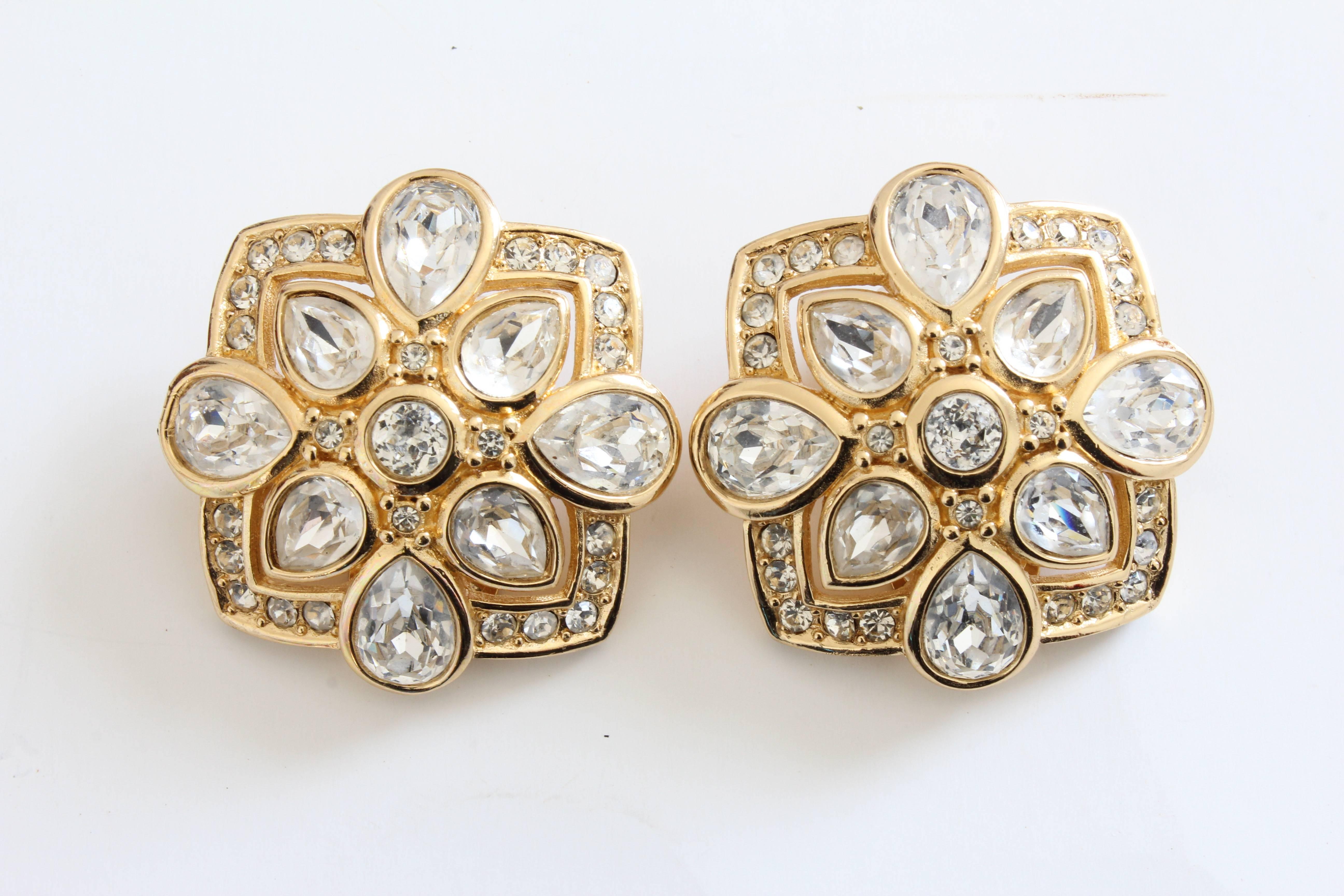 Here's a pair of earrings from Christian Dior, likely made in the 1990s.  Made from gold metal, they feature large pear shaped rhinestones along with smaller inset stones.  Clip style.  In excellent preowned condition.  They measure appx 1.25in