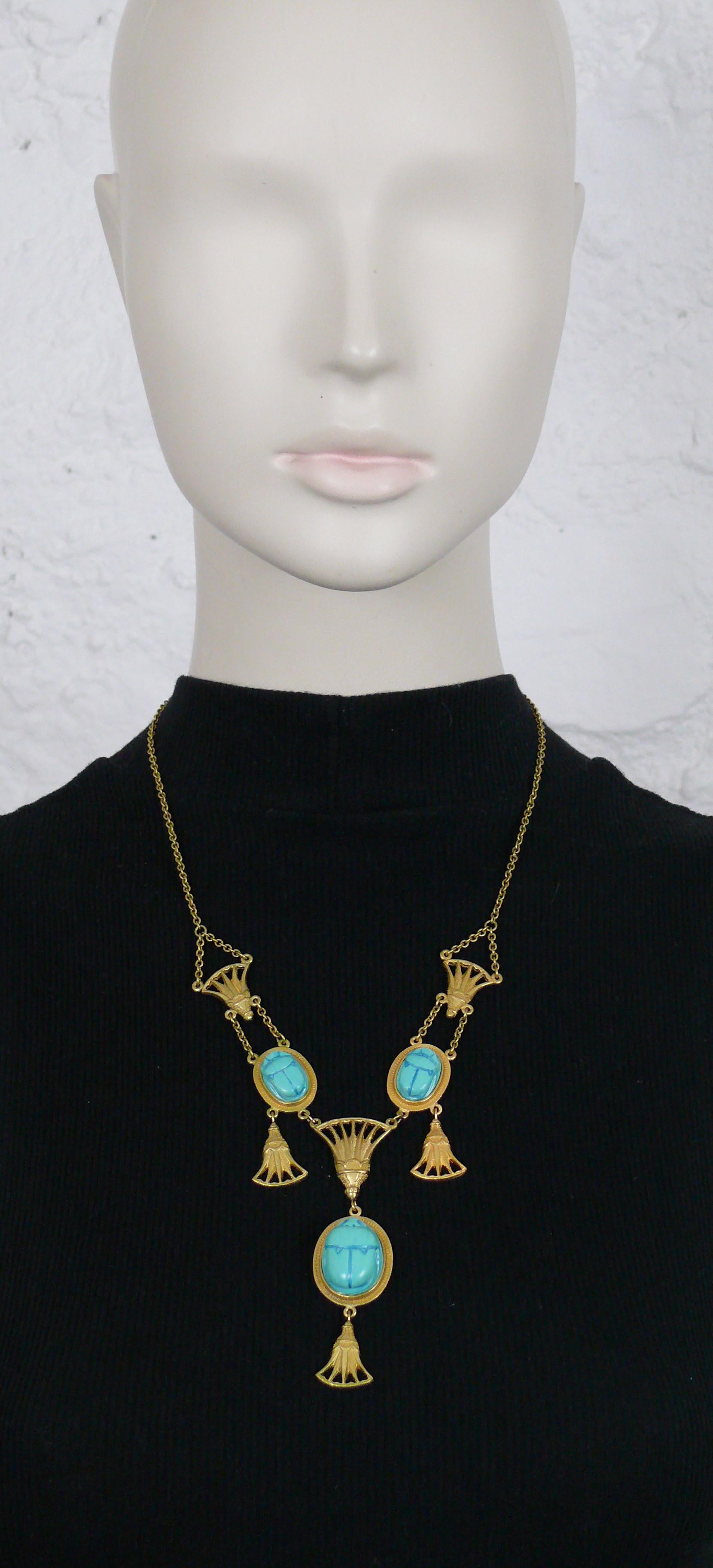 CHRSITIAN DIOR Egyptian revival matte gold toned necklace featuring a thin link chain, antique ornament and faux turquoise scarabs.

Lobster clasp closure.

Spring/Summer collection 2004.

Embossed DIOR ©.

Indicative measurements : length approx.