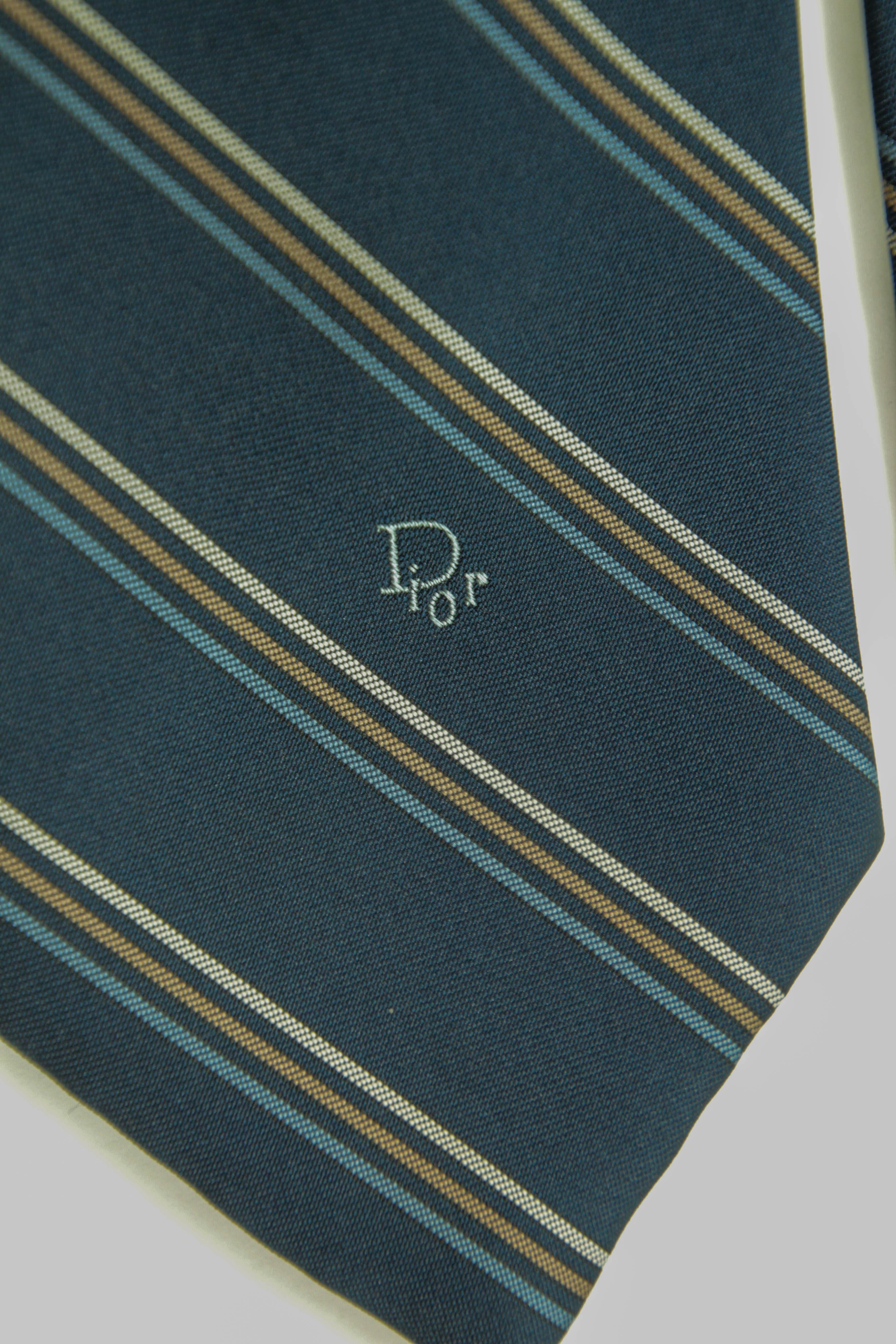 Vintage Christian Dior Elegant Classic Necktie 1990.
Vintage Silk Neck Tie in Blue Colors with the Dior logo.
A timeless classic, this tie is designed by the famous designer Christian Dior. 
Blue background decorated with stripes in brown. light