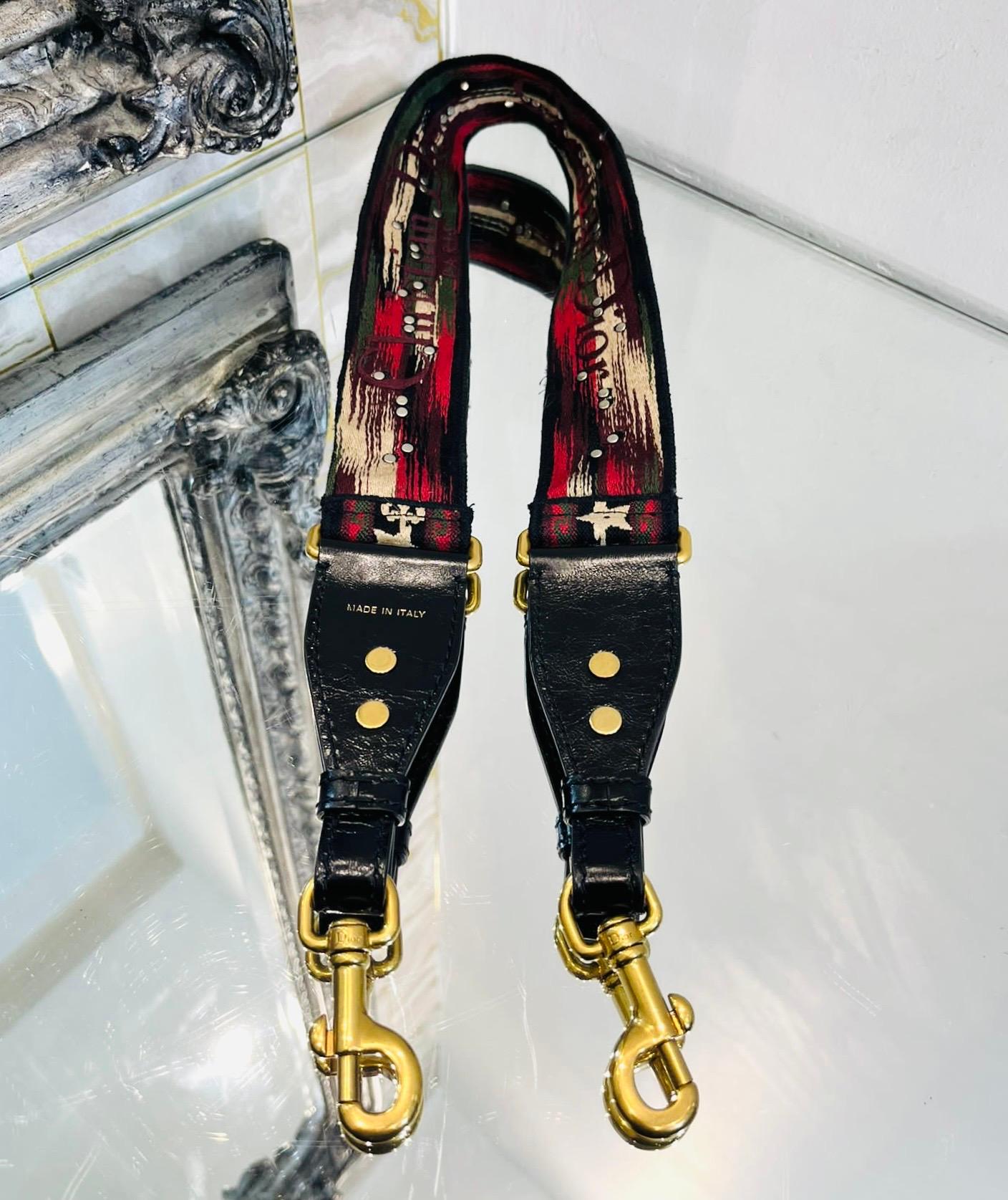 Christian Dior Embroidered Canvas Bag Strap

Multicoloured shoulder strap designed with metal studded emblems throughout.

Featuring 'Christian Dior' lettering to reverse, black leather ends and gold lobster clasp closure detailed with 'Dior'