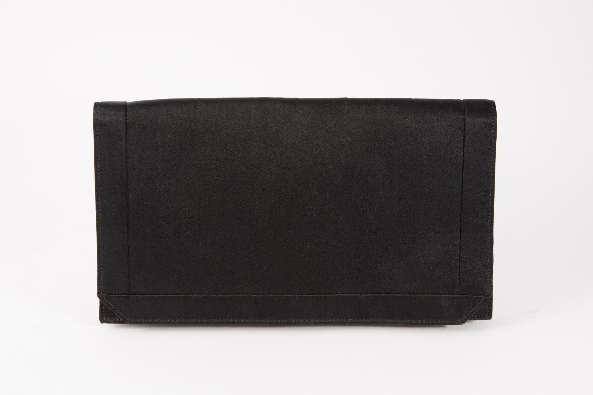 Christian Dior evening black silk clutch featuring a front snap closure, an inside stamped many compartments.  
In good vintage condition. Made in France.
Length:9.05in. (23cm)
Width 5.1in. (13cm)
 Depth 1.9in. (5cm) 
We guarantee you will receive