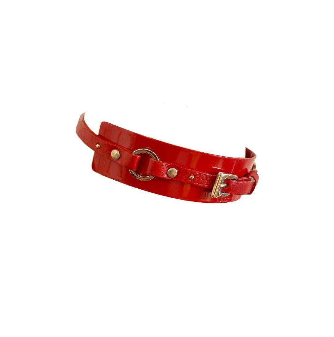 Christian Dior Bondage Red Choker from the Fall/Winter 2003 “Hardcore” collection by John Galliano. Red metal plaque with matching red leather strap, adjustable closure.

Runway piece as seen on the runway on Liisa Winkler and Fernanda