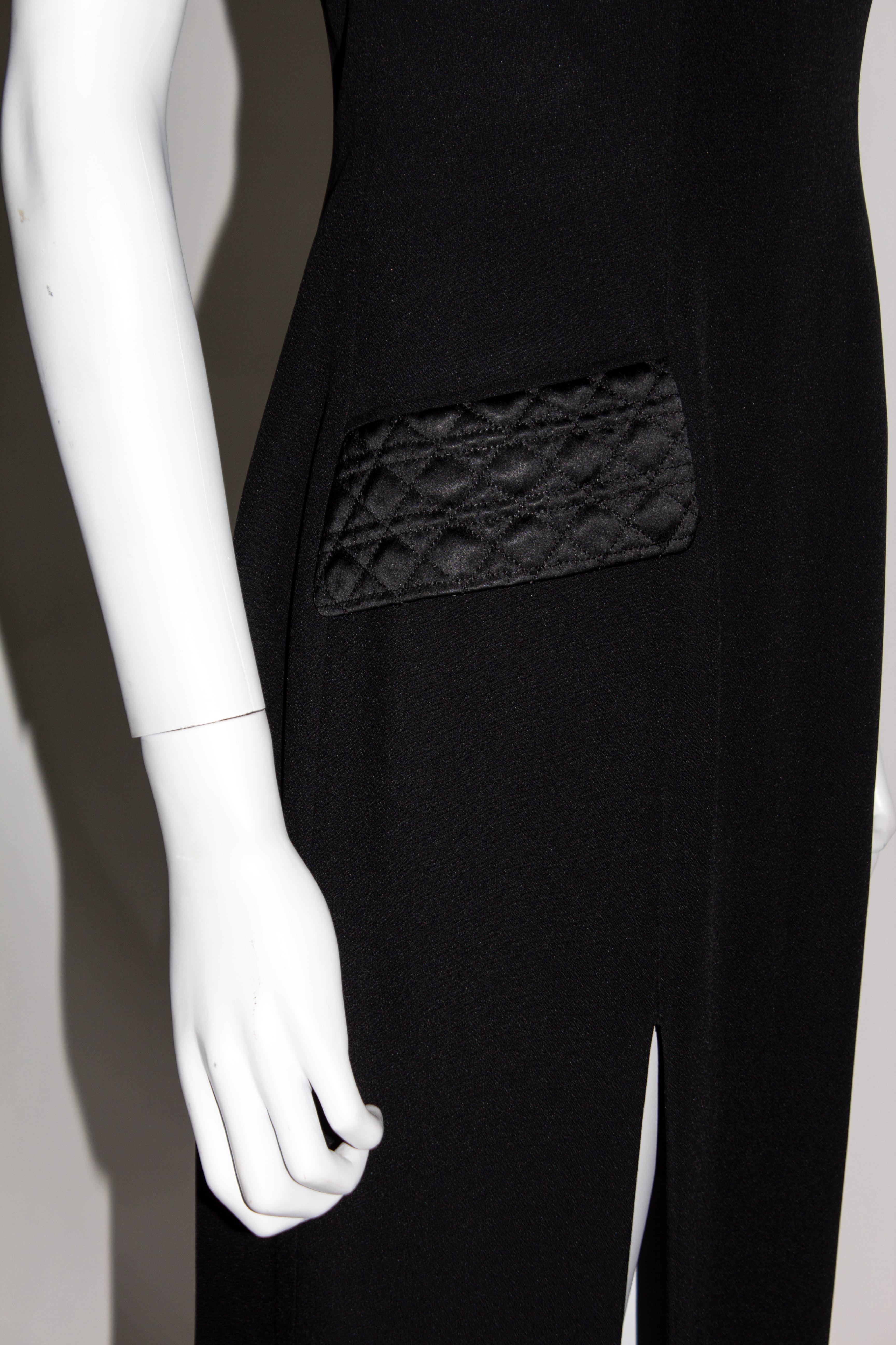 Christian Dior long black strapless dress with a built in corseted bust, slit to the front and satin quilted pockets. The hem lining is also beautifully finished in the same quilted trim. Designed by John Galliano for his first ever ready to wear